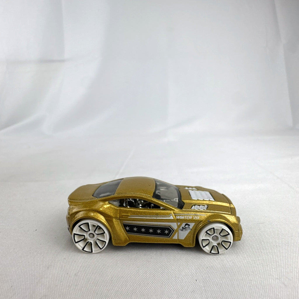Hot Wheels 1:64 scale Torque Twister diecast car in gold from the 2020 Winter Series