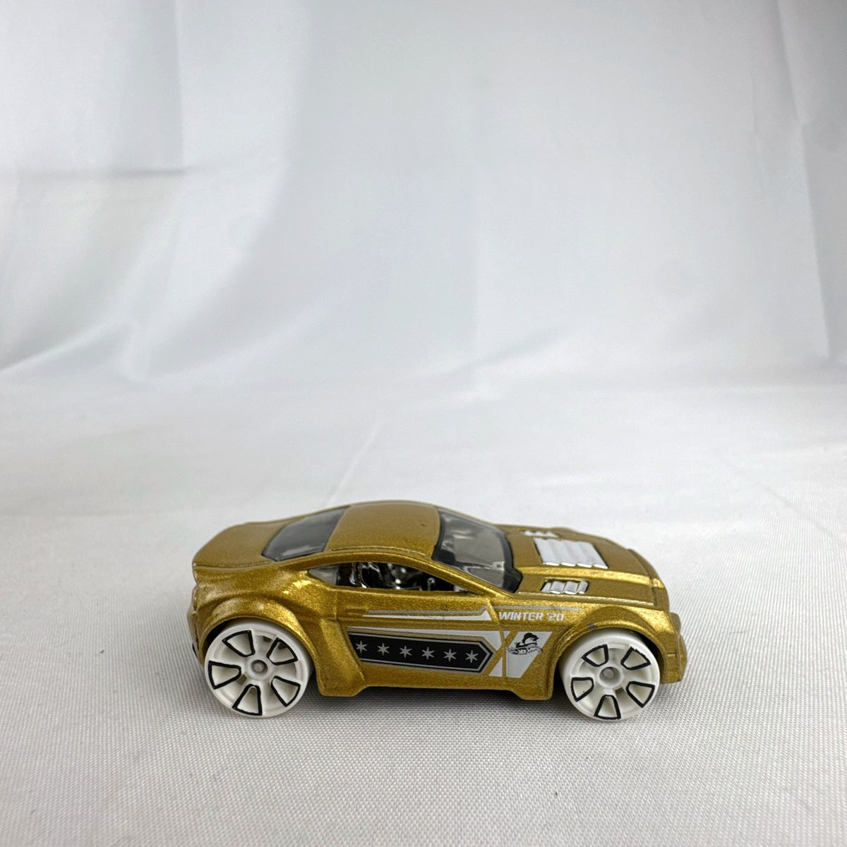 Hot Wheels 1:64 scale Torque Twister diecast car in gold from the 2020 Winter Series