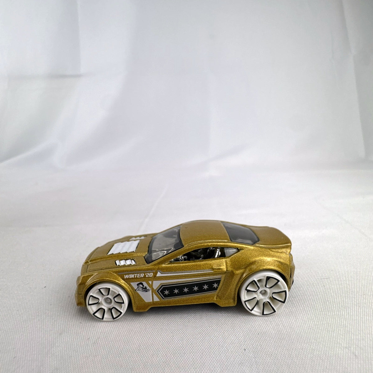 Hot Wheels 1:64 scale Torque Twister diecast car in gold from the 2020 Winter Series