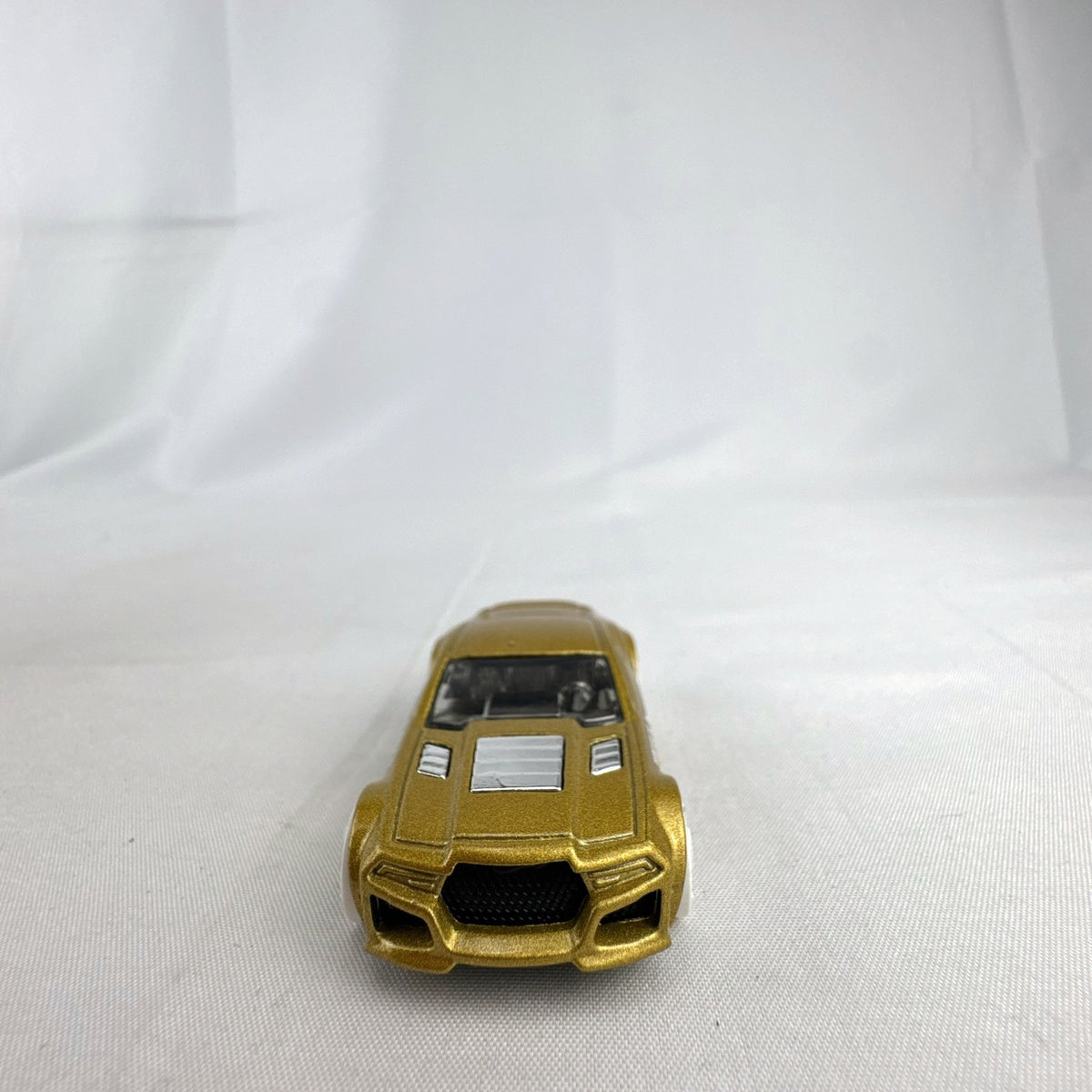 Hot Wheels 1:64 scale Torque Twister diecast car in gold from the 2020 Winter Series