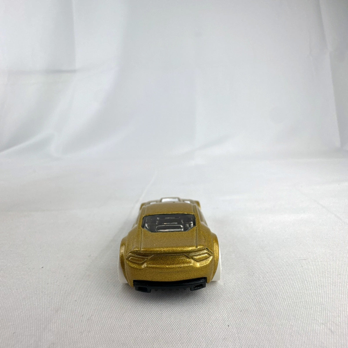 Hot Wheels 1:64 scale Torque Twister diecast car in gold from the 2020 Winter Series