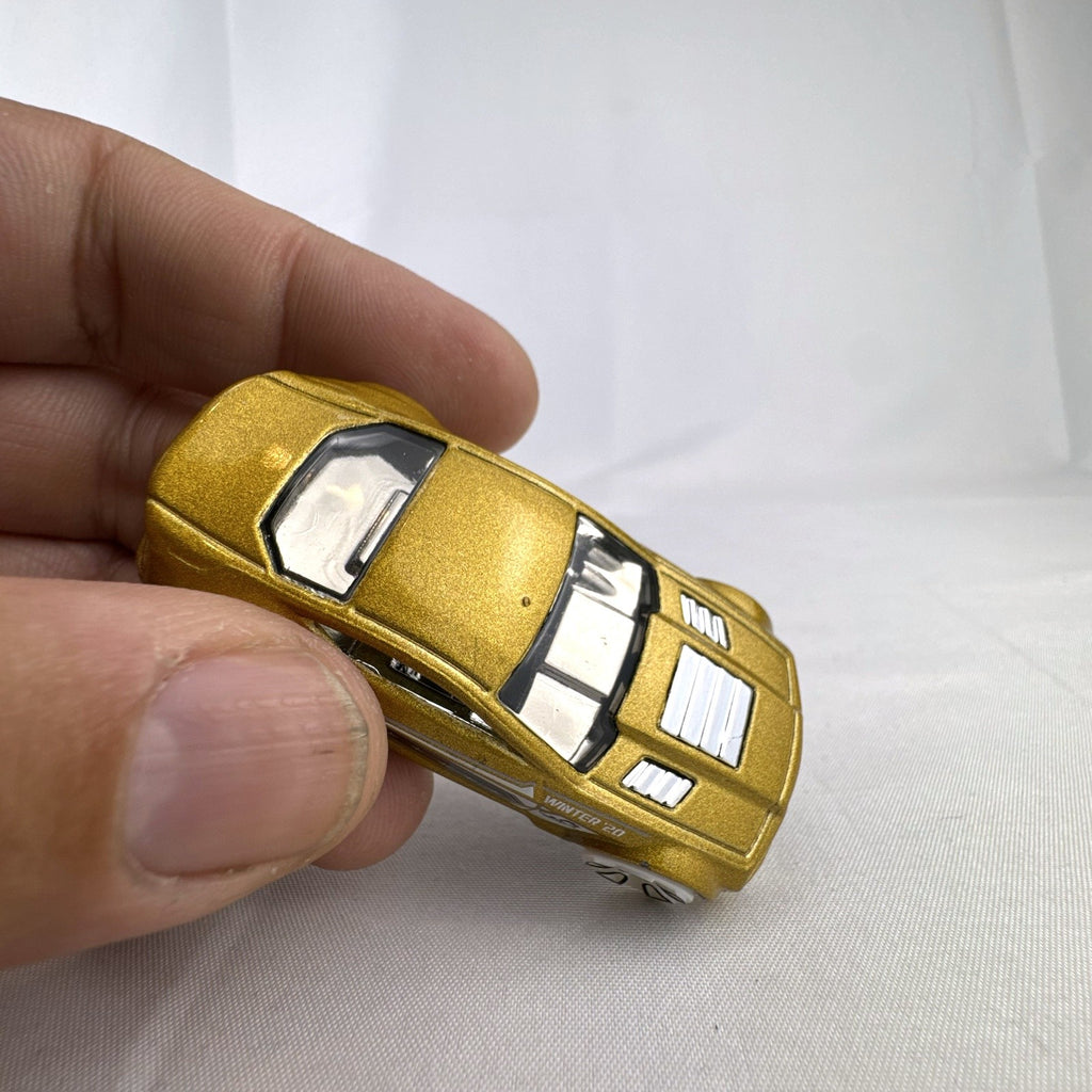 Hot Wheels 1:64 scale Torque Twister diecast car in gold from the 2020 Winter Series