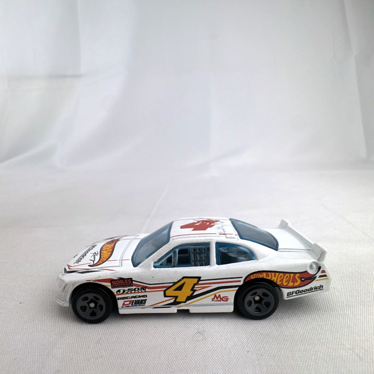 Hot Wheels 1:64 scale 2010 Chevrolet Impala stock car in white with number 4 racing livery