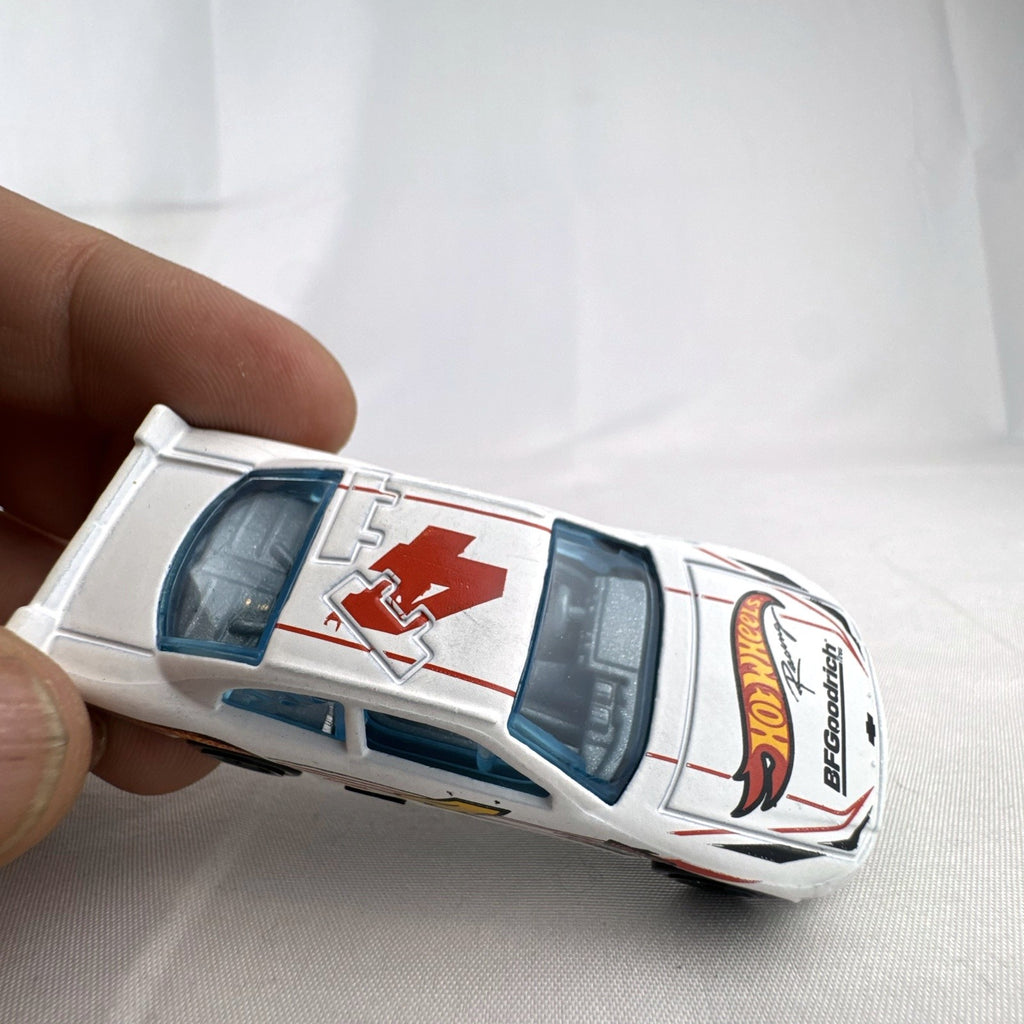 Hot Wheels 1:64 scale 2010 Chevrolet Impala stock car in white with number 4 racing livery