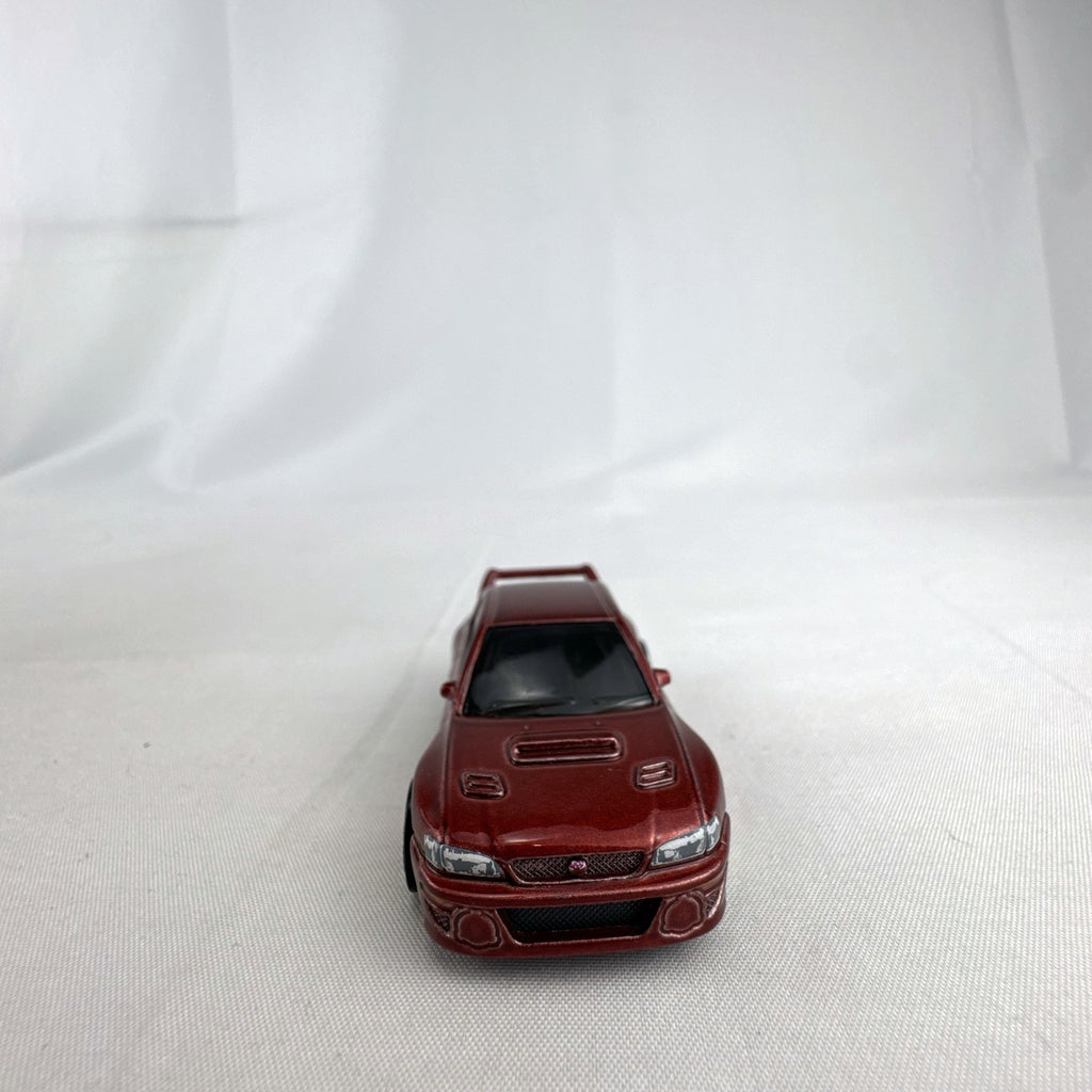 Hot Wheels 1:64 scale 1998 Subaru Impreza 22B STi-Version diecast car in dark metallic red with gold wheels