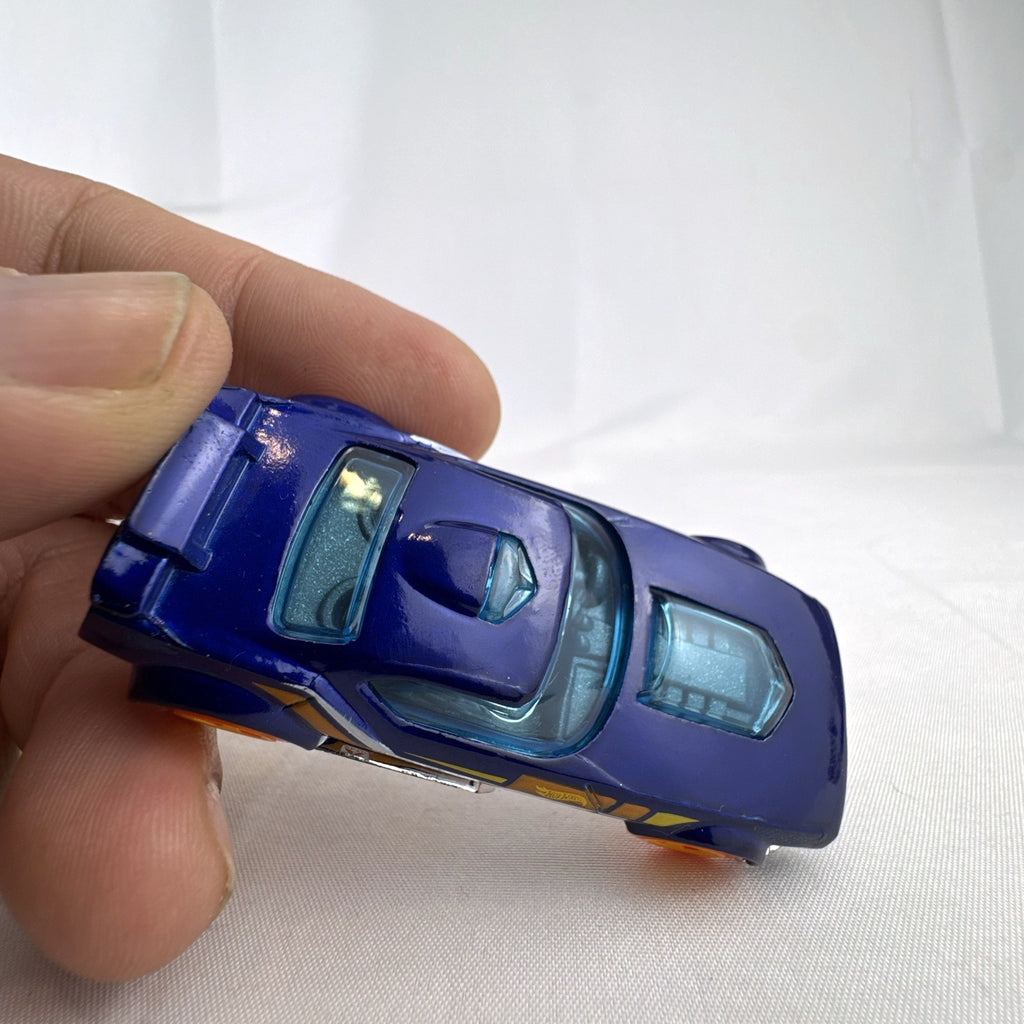 Hot Wheels Fast Fish 1:64 scale diecast car in dark blue with orange 5-spoke wheels and chrome base