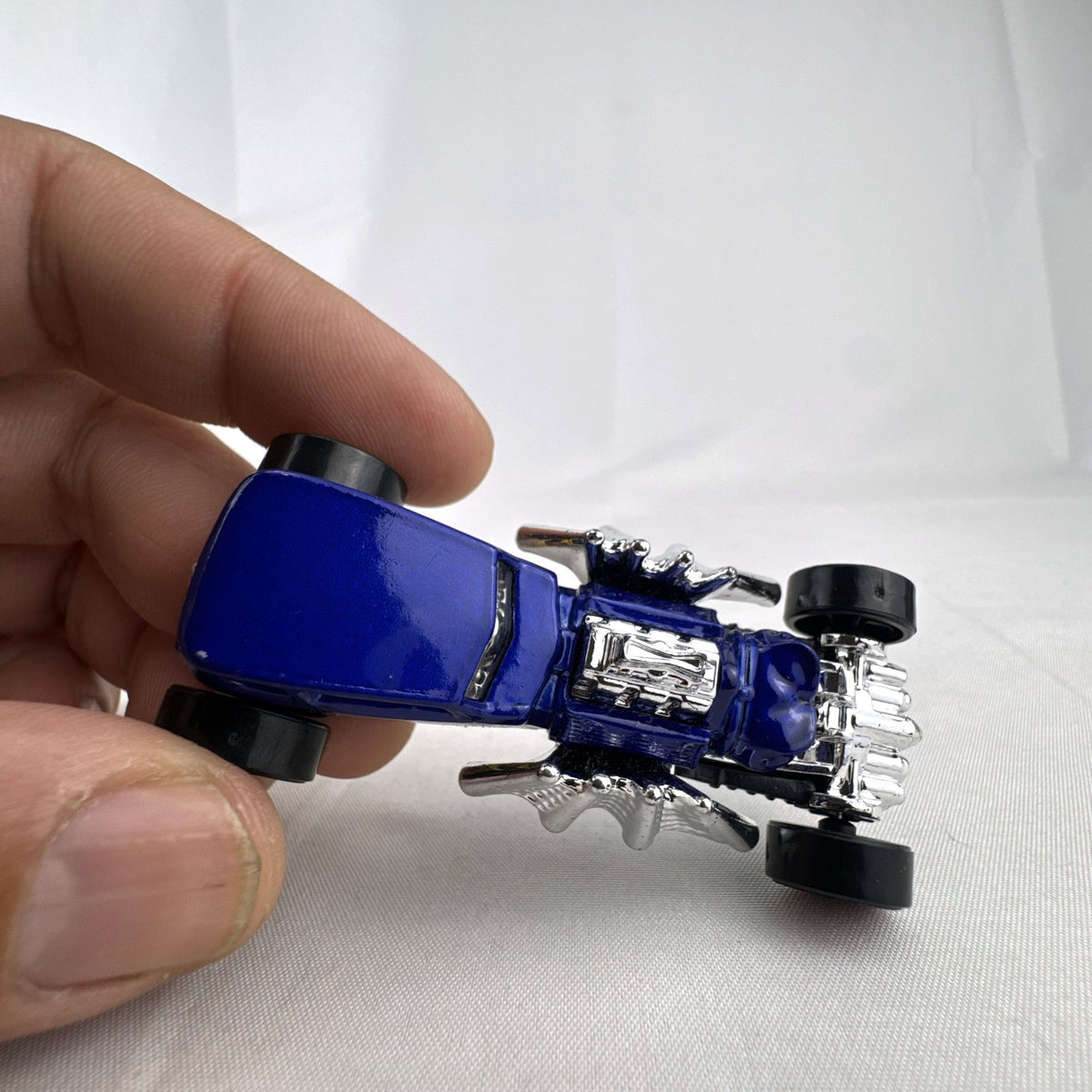 Blue Hot Wheels Street Creeper 1:64 scale diecast car featuring chrome spider engine block