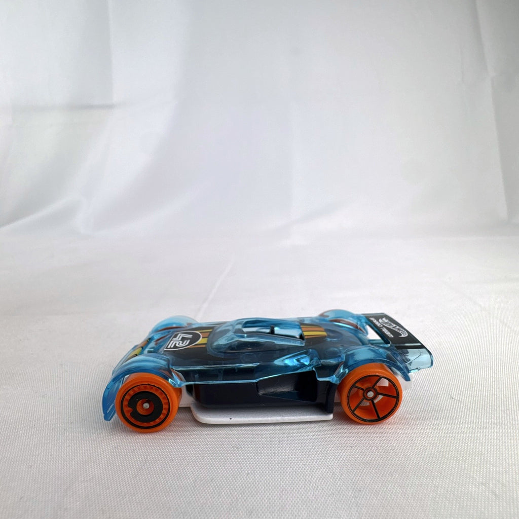 Hot Wheels Mach It Go 1:64 scale diecast race car in translucent blue with orange wheels and number 42 livery