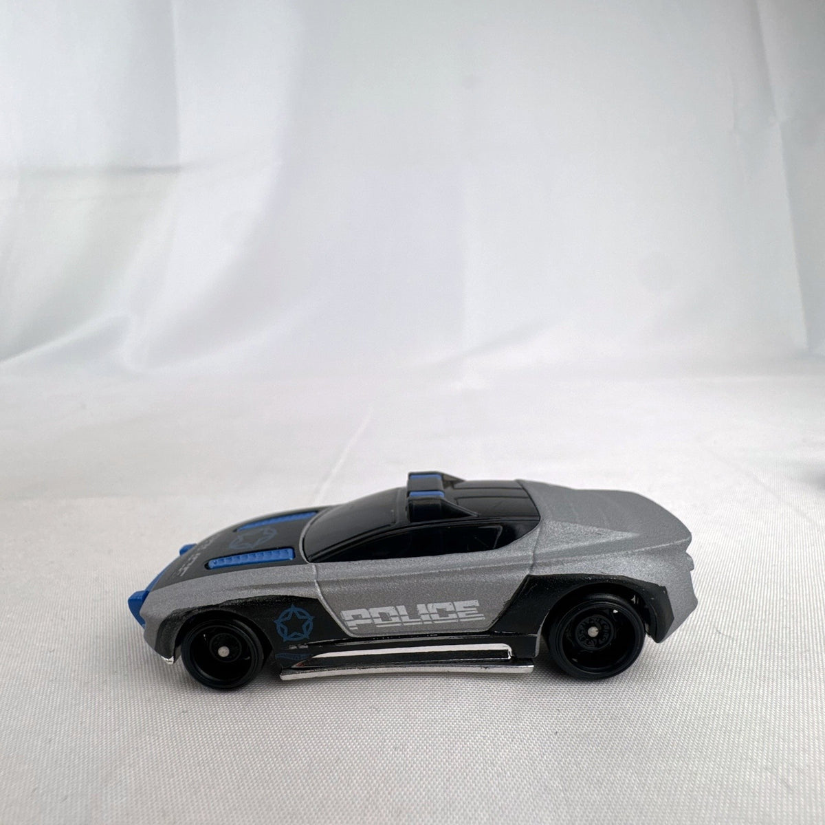 Hot Wheels Alpha Pursuit 1:64 scale police interceptor diecast car in metallic silver and black