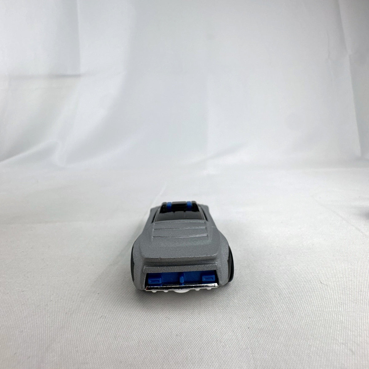 Hot Wheels Alpha Pursuit 1:64 scale police interceptor diecast car in metallic silver and black