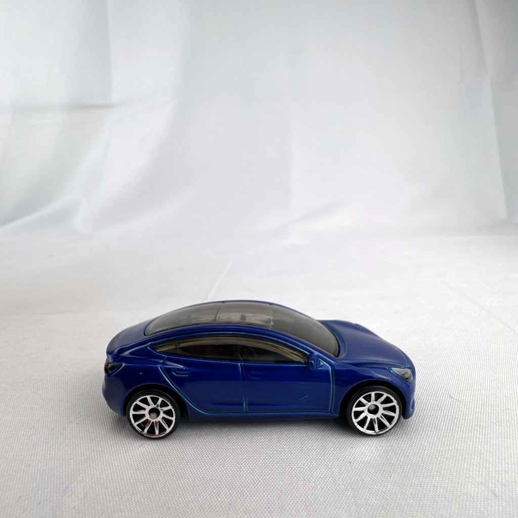 Hot Wheels 1:64 scale metallic blue Tesla Model 3 diecast car with smoke-tinted glass roof