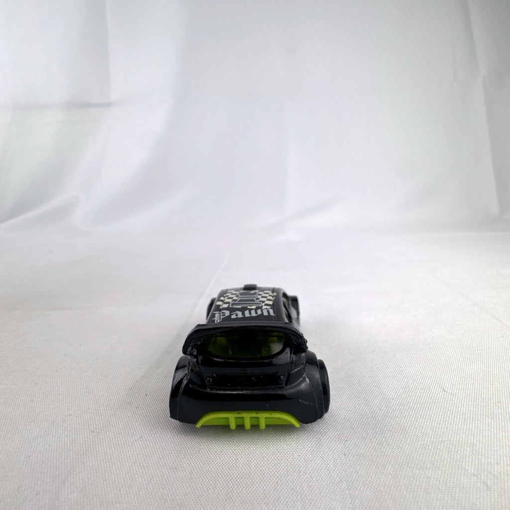 Hot Wheels 1:64 scale 2012 Ford Fiesta diecast car in black with green trim and HW Checkmate pawn graphics