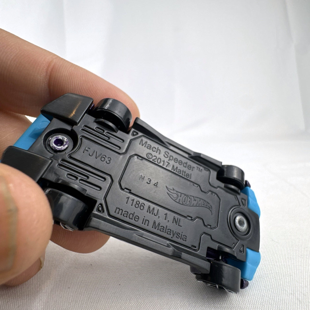 Hot Wheels Mach Speeder 1:64 scale diecast car in metallic purple with light blue accents