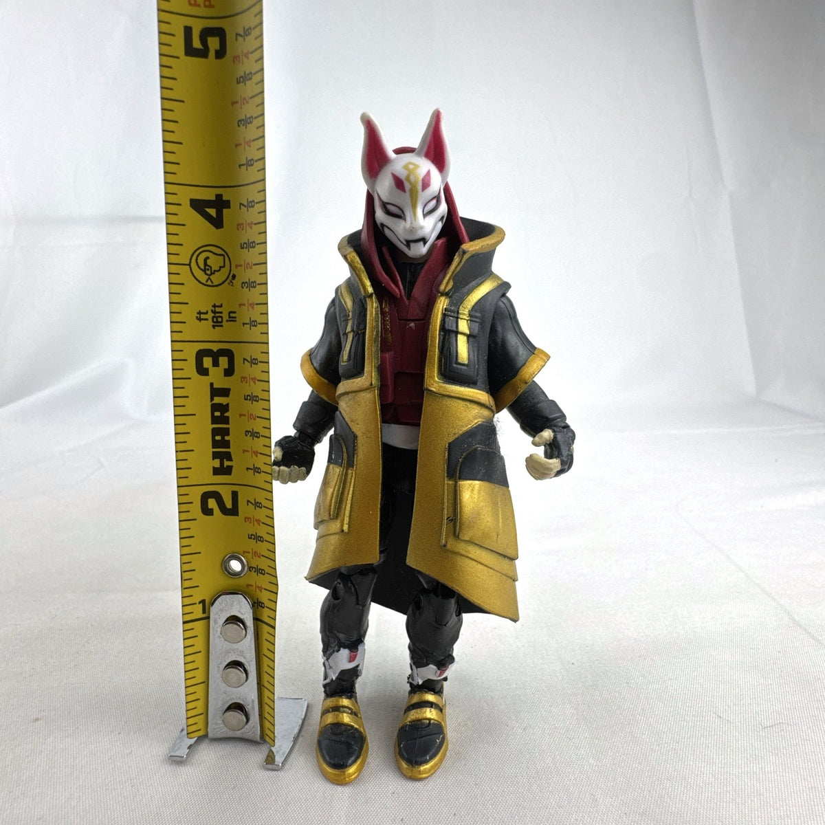 Jazwares Fortnite Drift Stage 5 four-inch action figure wearing black and gold cloak and Kitsune mask