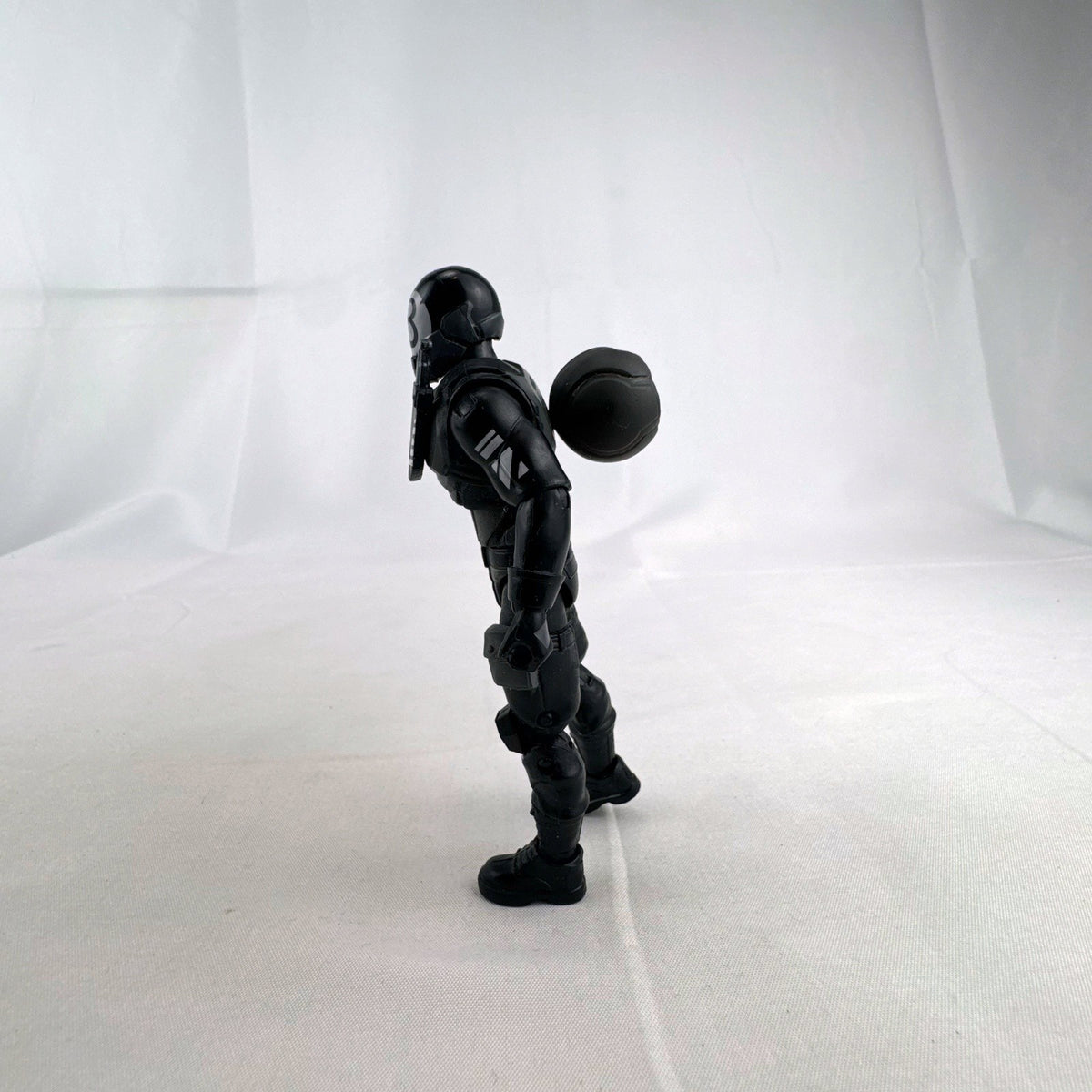 Jazwares Fortnite Solo Mode 4-inch 8-Ball action figure in black suit with back bling accessory