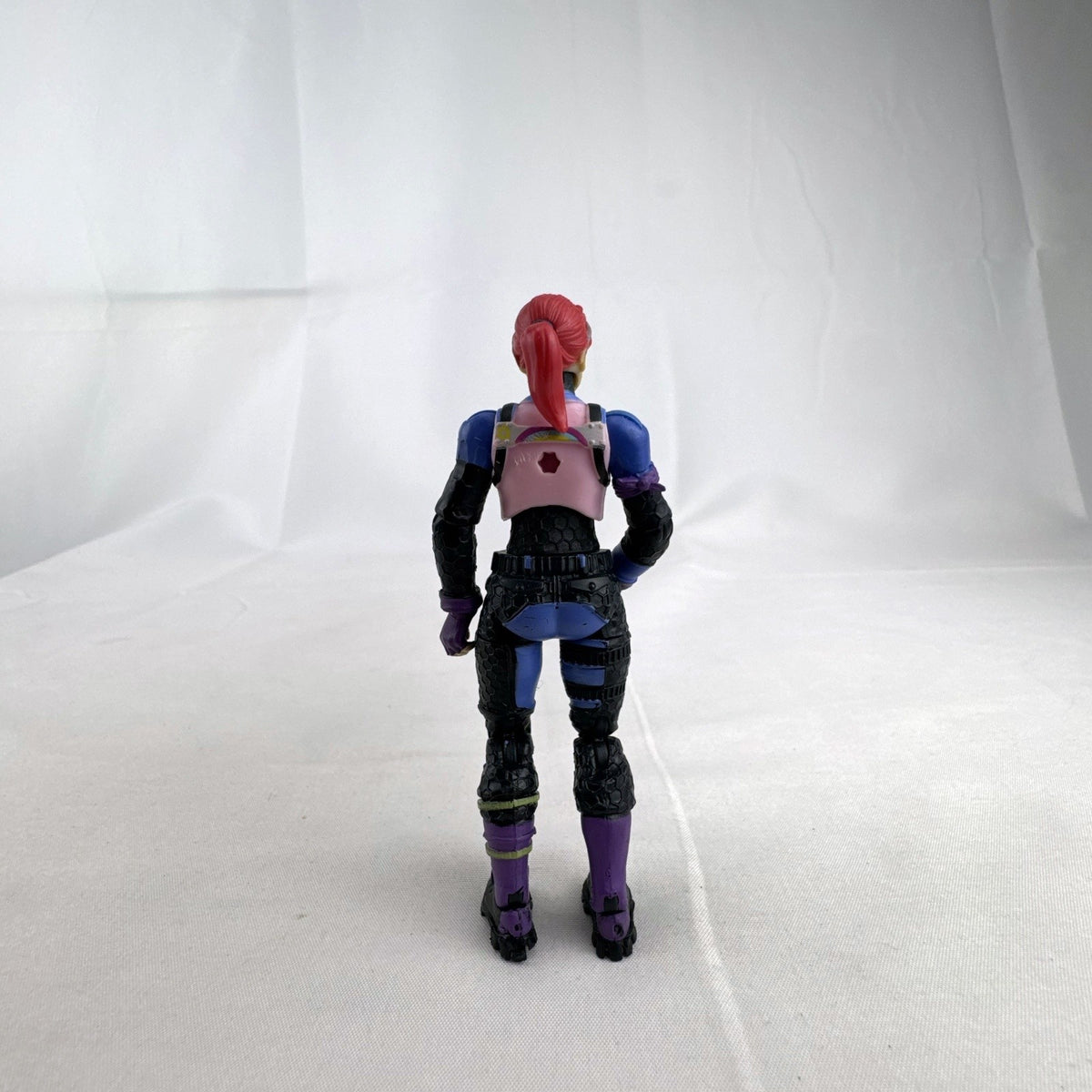Jazwares Fortnite 4-inch Brite Bomber action figure with pink hair and unicorn chest design