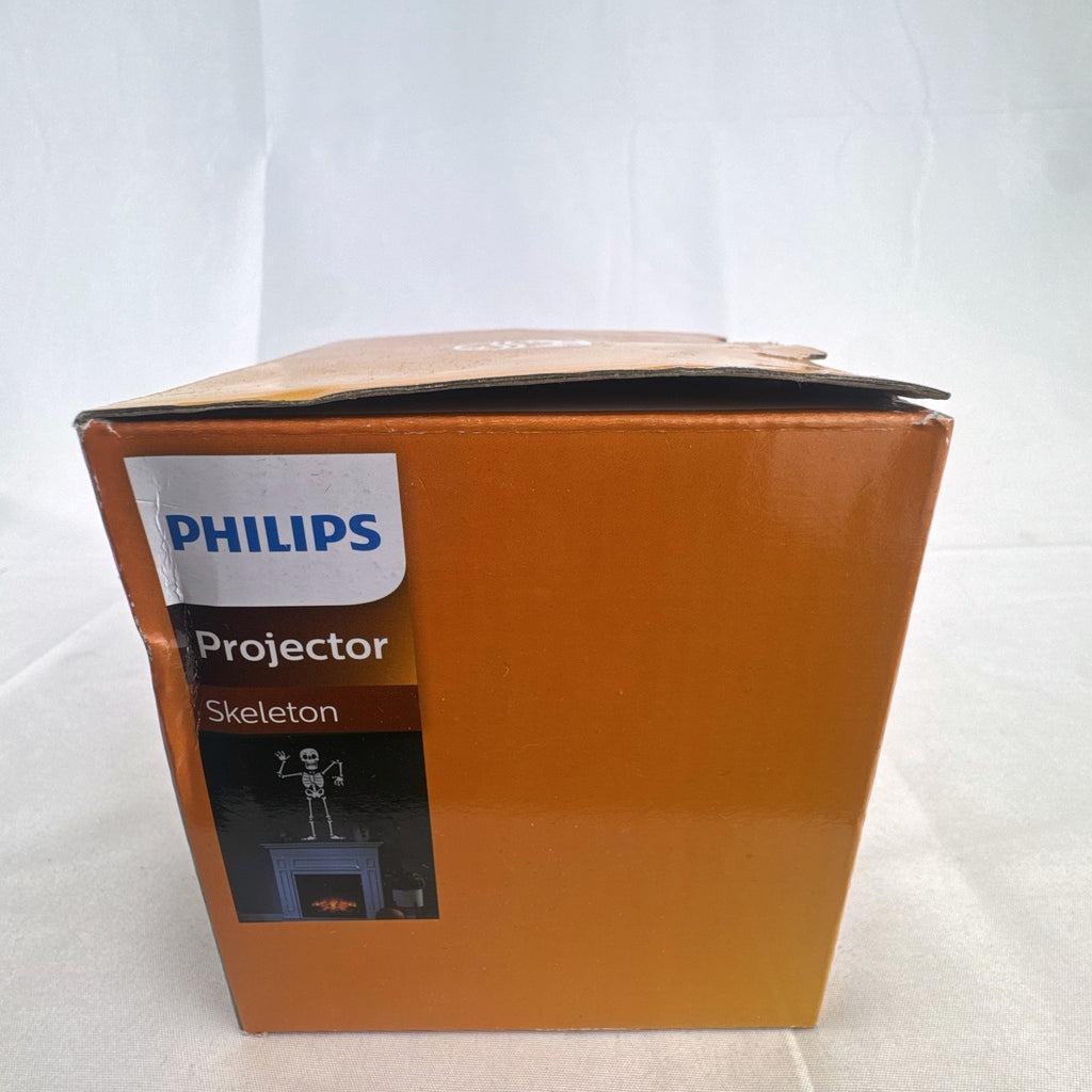 Philips black battery-operated Halloween LED projector casting a cool white skeleton light display.