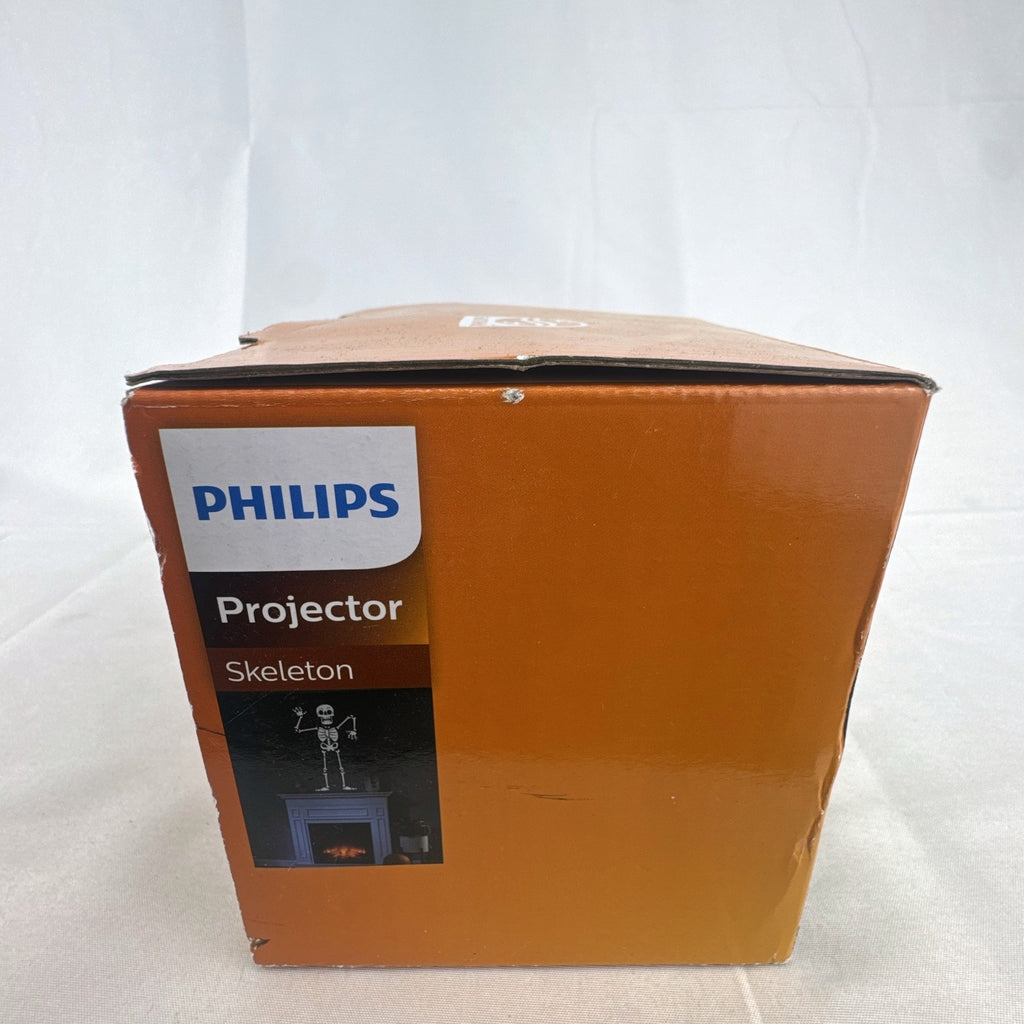 Philips black battery-operated Halloween LED projector casting a cool white skeleton light display.