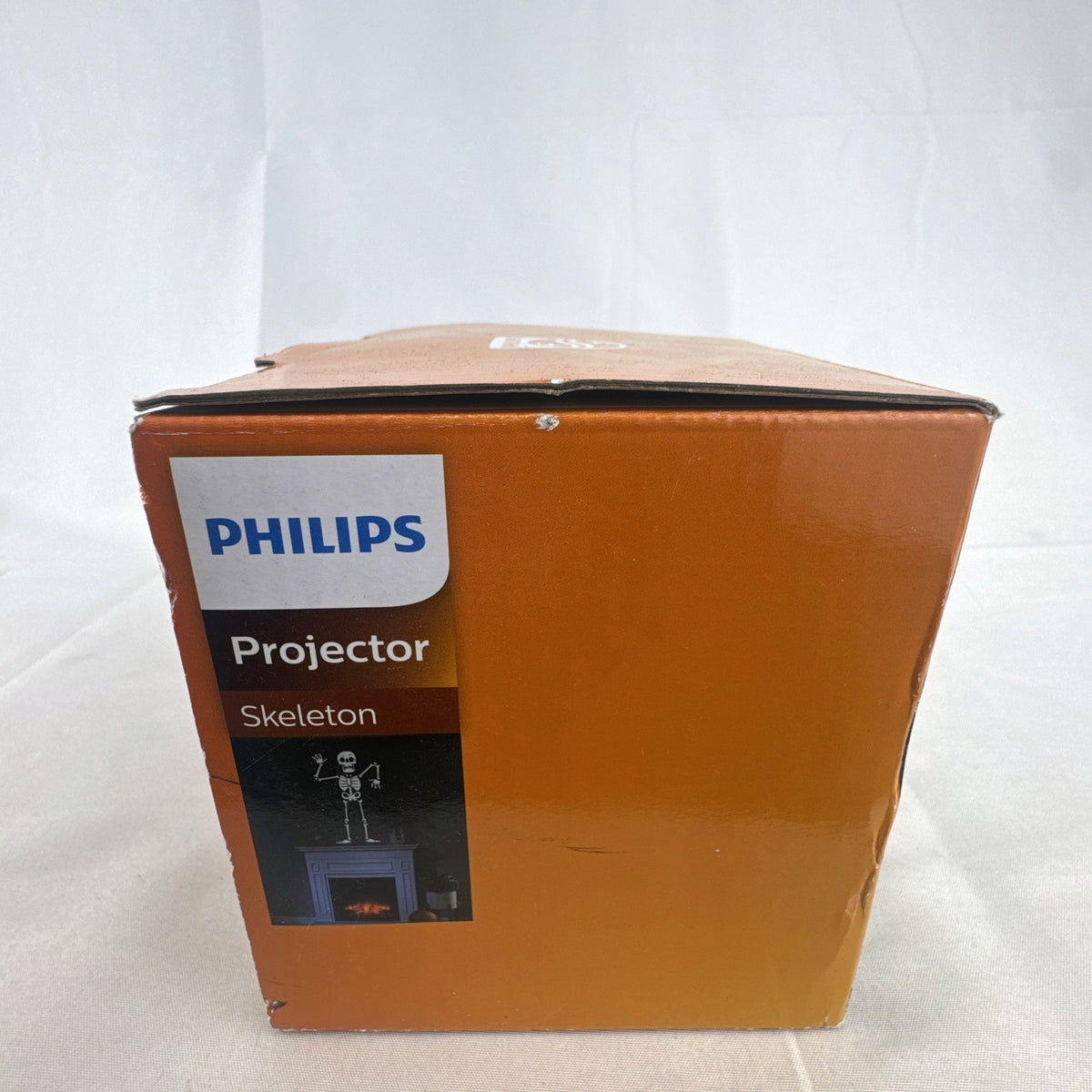 Philips black battery-operated Halloween LED projector casting a cool white skeleton light display.