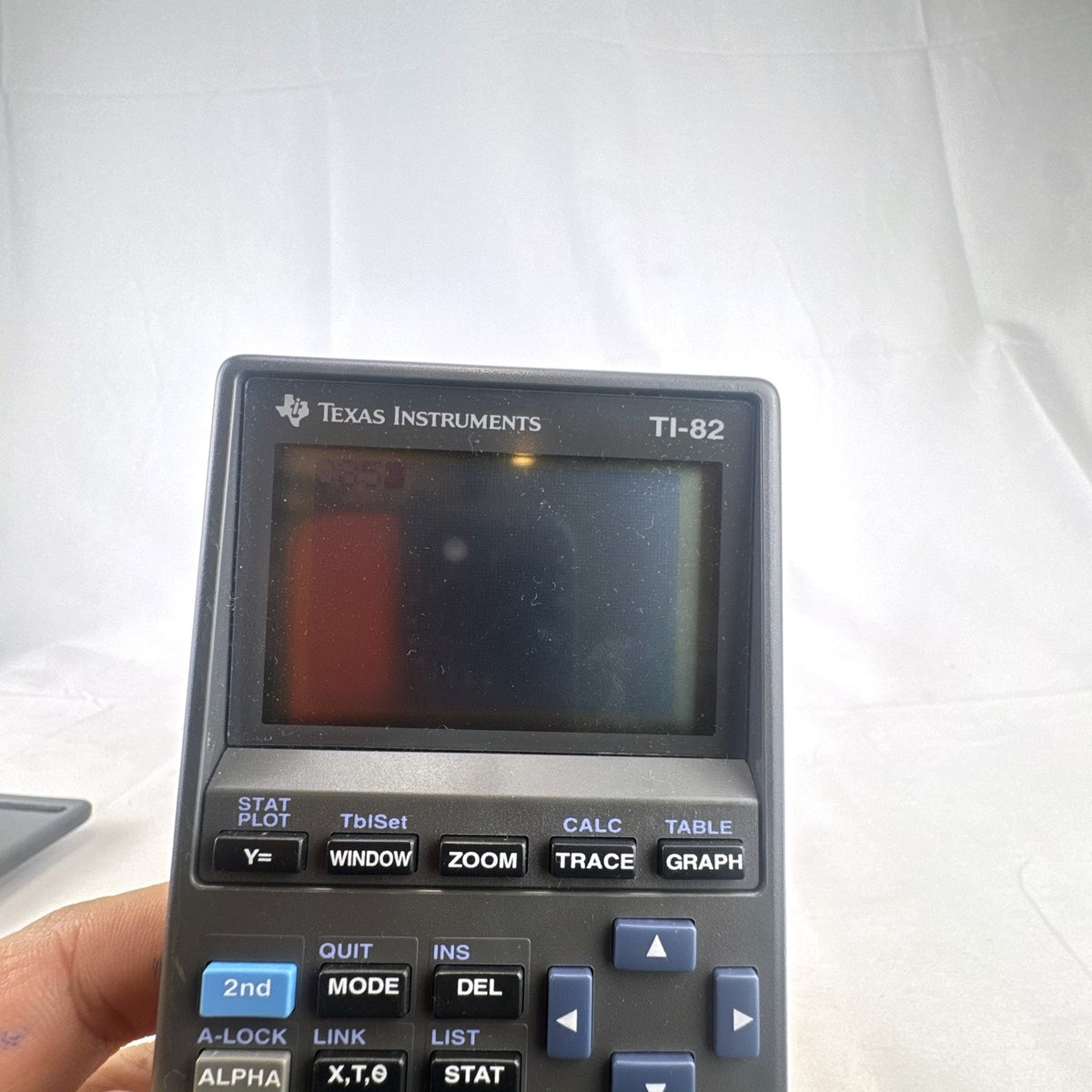 Texas Instruments TI-82 handheld graphing calculator in matte dark gray