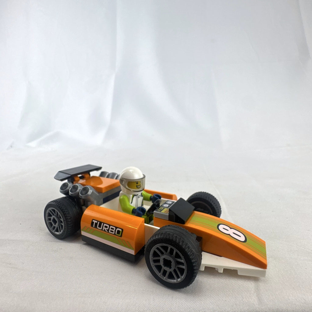 Assembled orange LEGO City 60322 Formula 1 style race car with driver minifigure