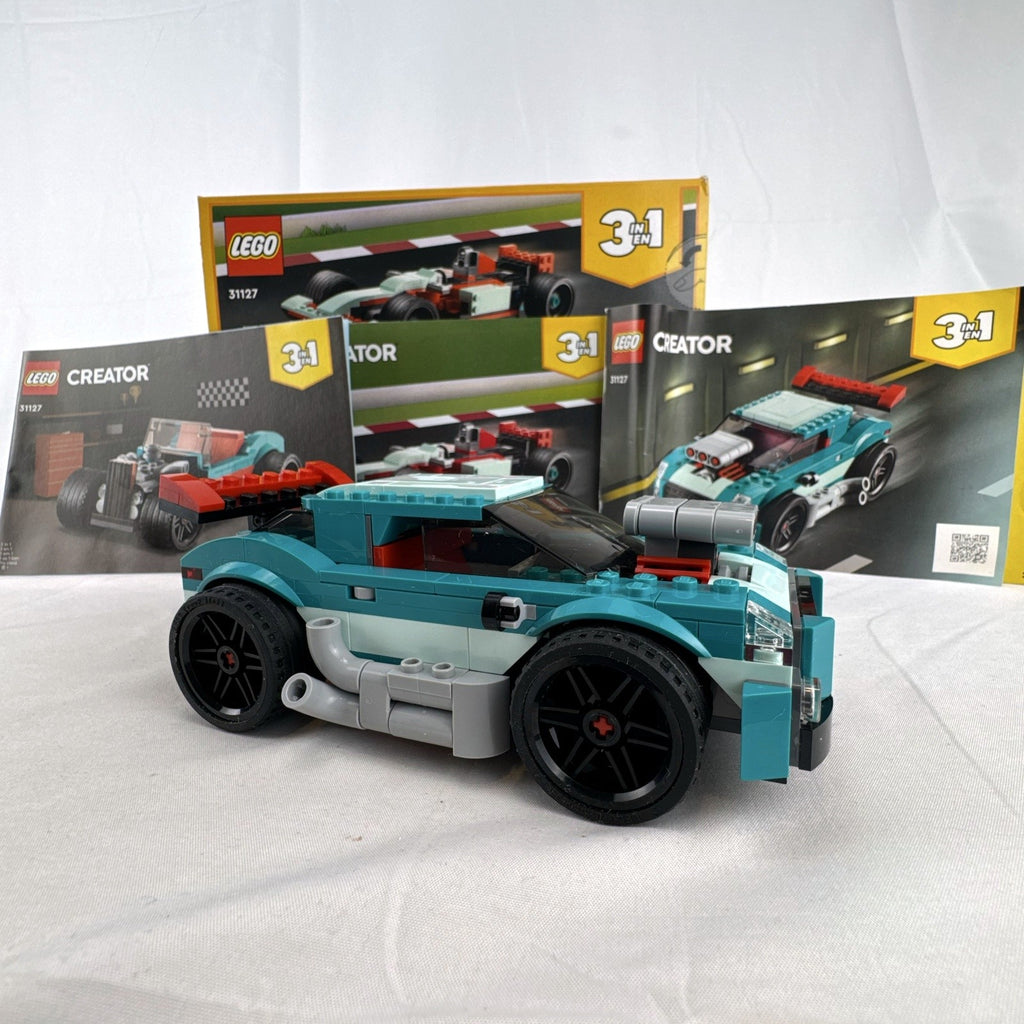 Assembled teal LEGO Creator 3-in-1 Street Racer car set 31127 with original box and instruction booklets
