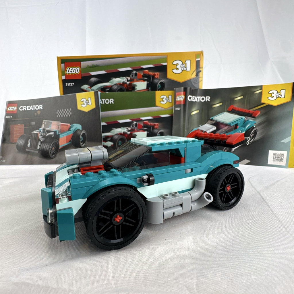Assembled teal LEGO Creator 3-in-1 Street Racer car set 31127 with original box and instruction booklets