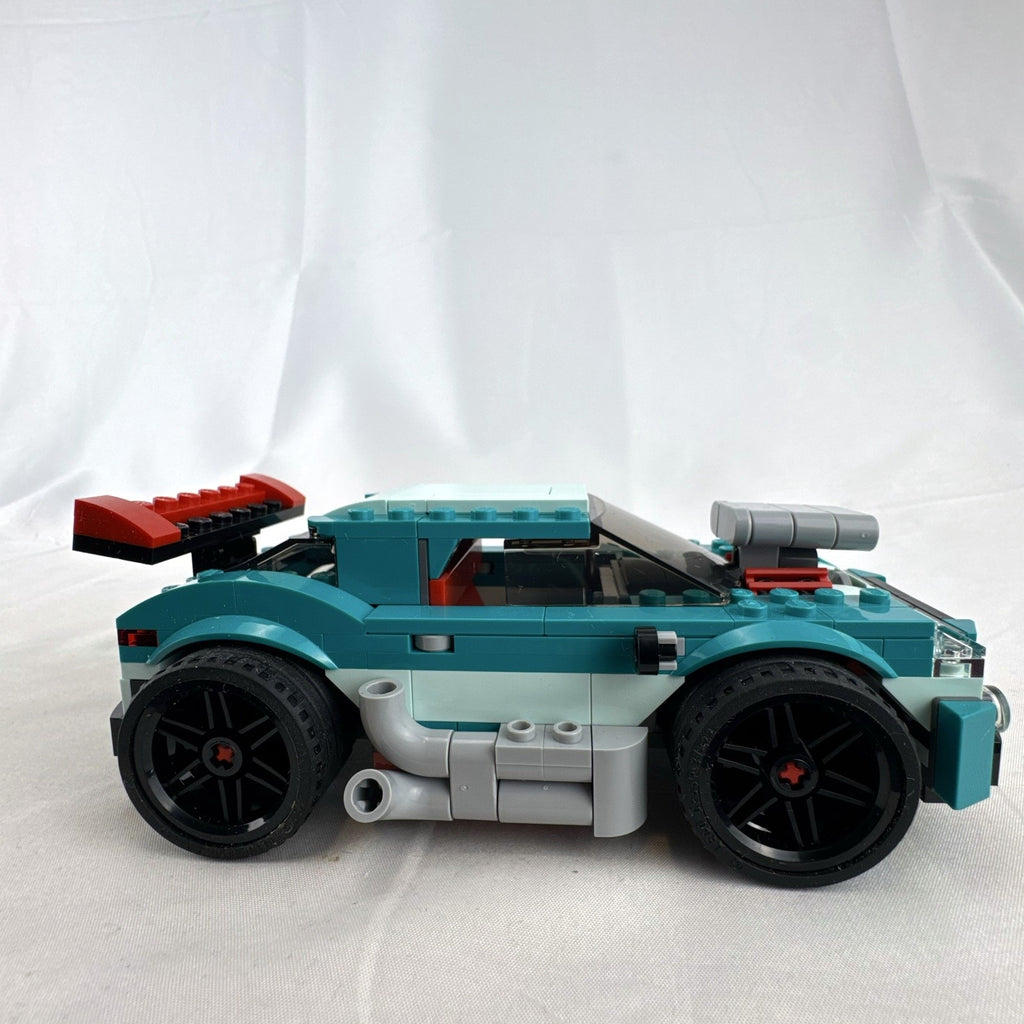 Assembled teal LEGO Creator 3-in-1 Street Racer car set 31127 with original box and instruction booklets