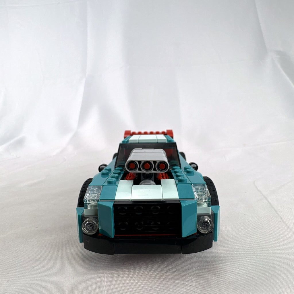 Assembled teal LEGO Creator 3-in-1 Street Racer car set 31127 with original box and instruction booklets
