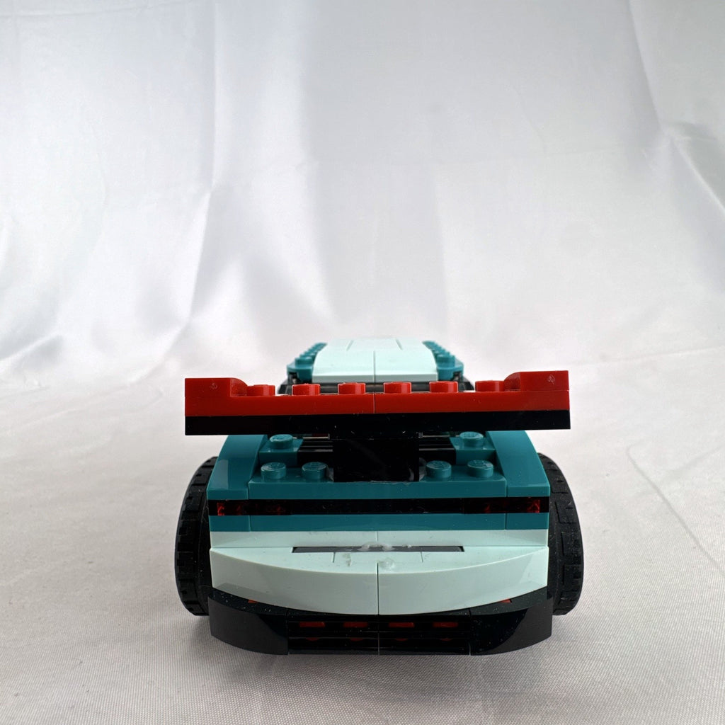 Assembled teal LEGO Creator 3-in-1 Street Racer car set 31127 with original box and instruction booklets