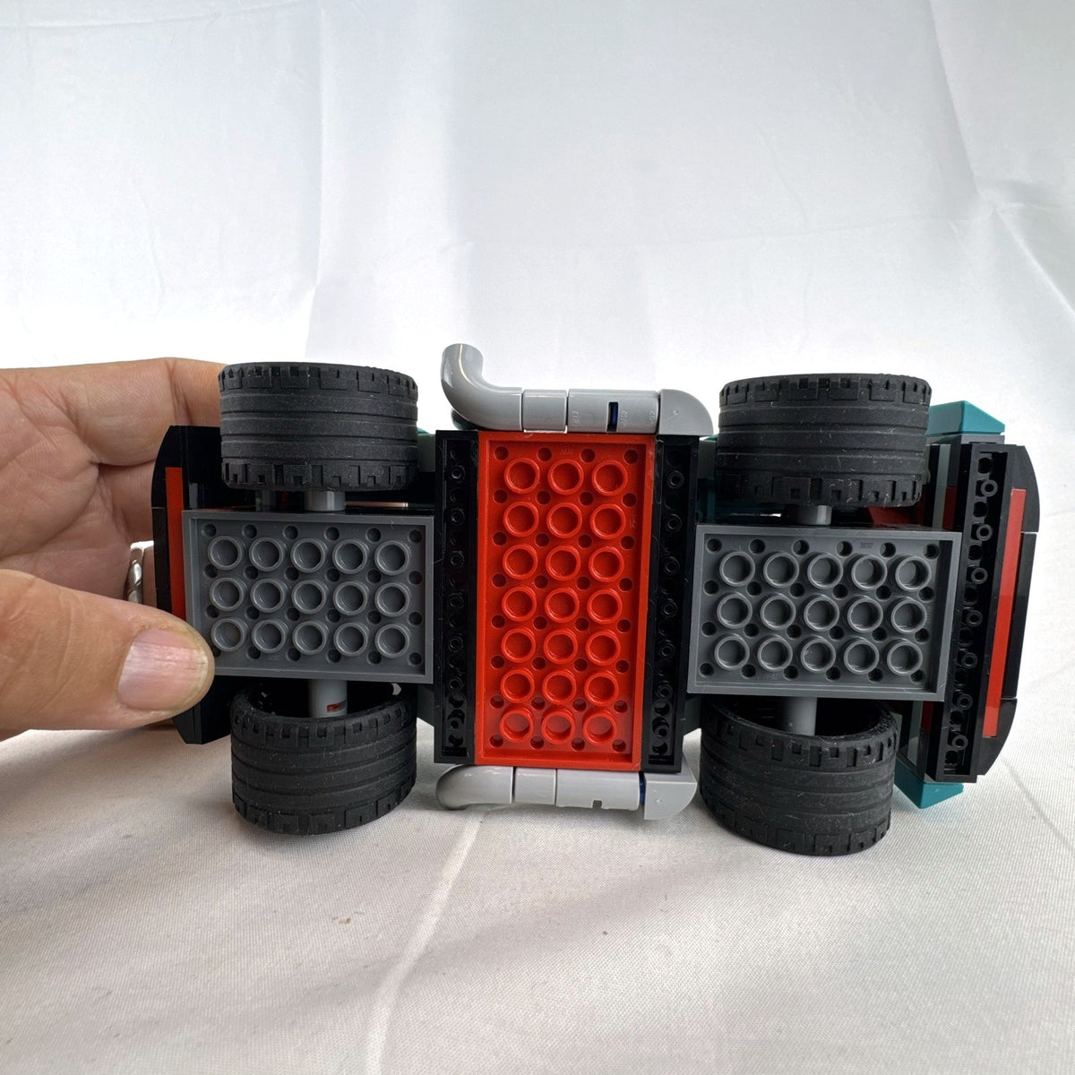 Assembled teal LEGO Creator 3-in-1 Street Racer car set 31127 with original box and instruction booklets