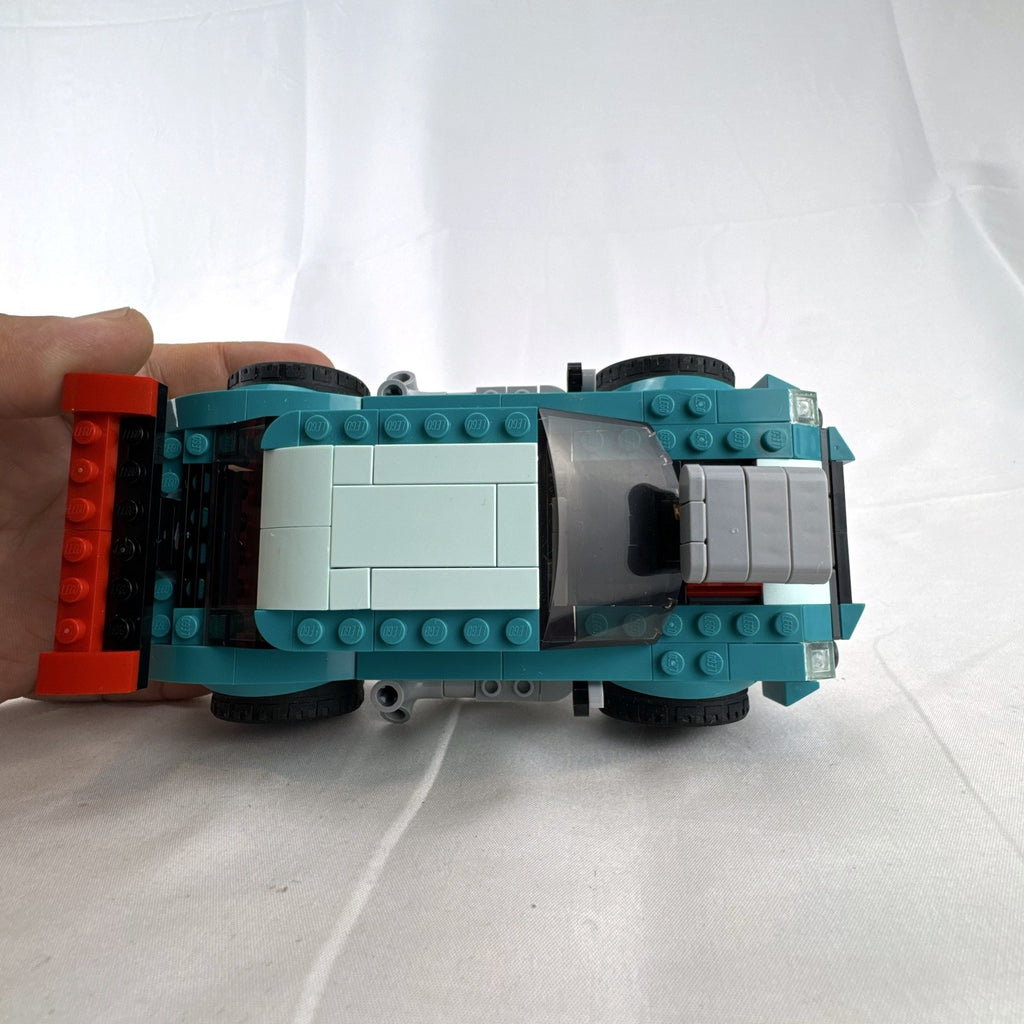 Assembled teal LEGO Creator 3-in-1 Street Racer car set 31127 with original box and instruction booklets