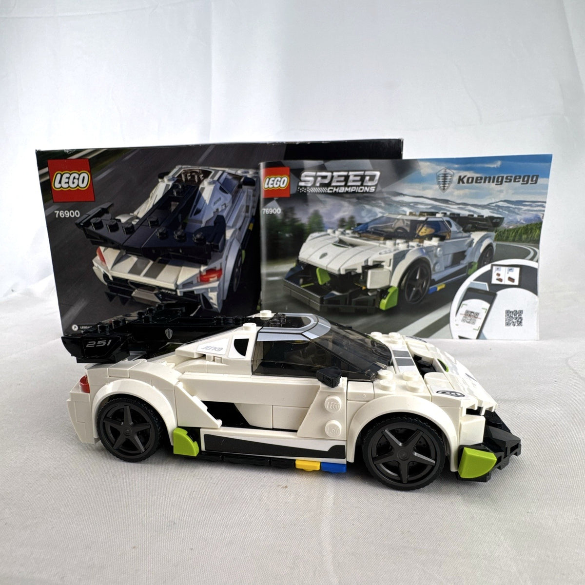 Assembled LEGO Speed Champions Koenigsegg Jesko 76900 white race car with original packaging and instruction booklet