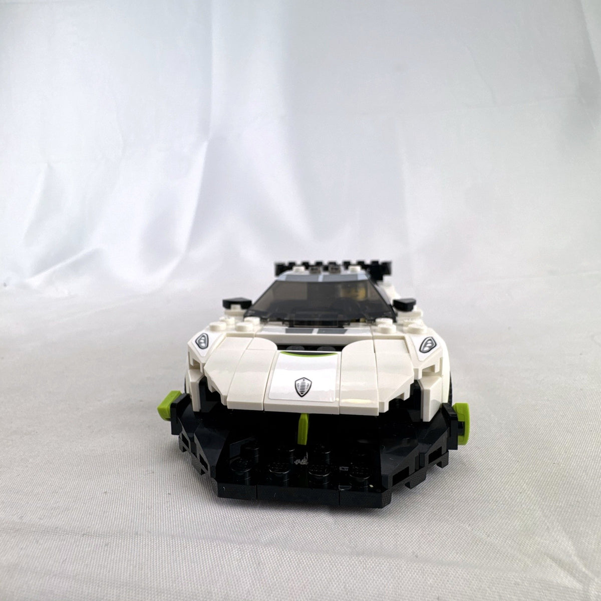 Assembled LEGO Speed Champions Koenigsegg Jesko 76900 white race car with original packaging and instruction booklet