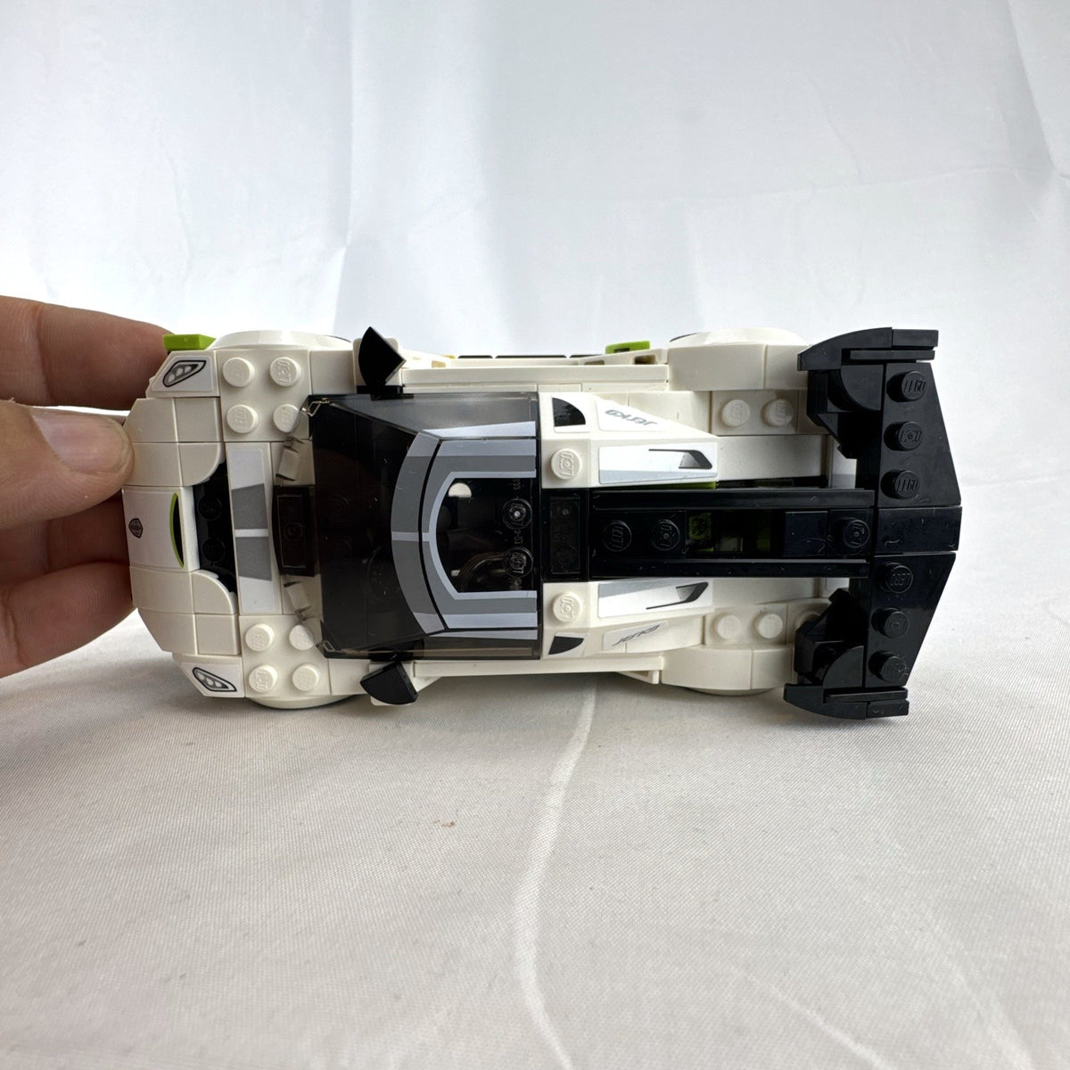 Assembled LEGO Speed Champions Koenigsegg Jesko 76900 white race car with original packaging and instruction booklet