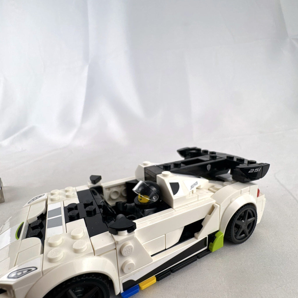 Assembled LEGO Speed Champions Koenigsegg Jesko 76900 white race car with original packaging and instruction booklet