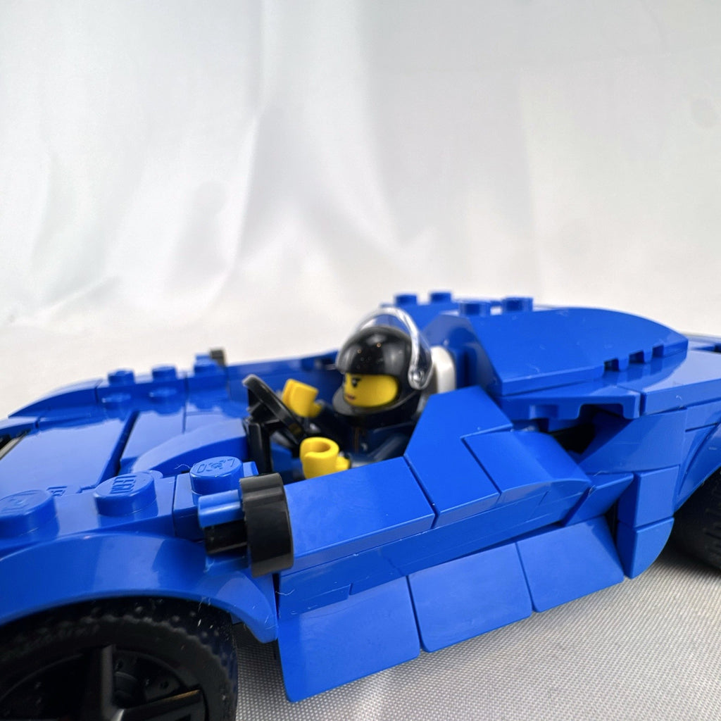 Assembled LEGO Speed Champions McLaren Elva set 76902 in blue with racing minifigure and original box