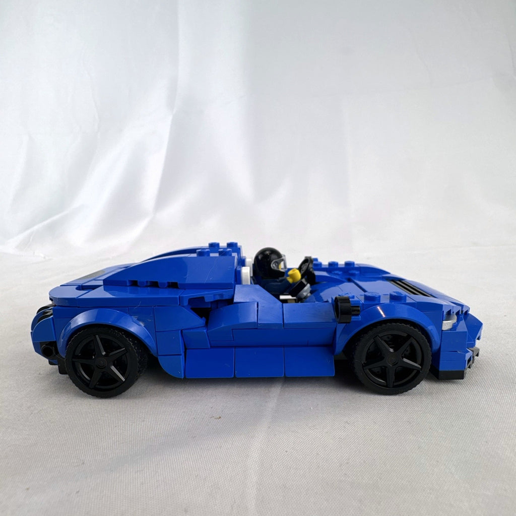 Assembled LEGO Speed Champions McLaren Elva set 76902 in blue with racing minifigure and original box