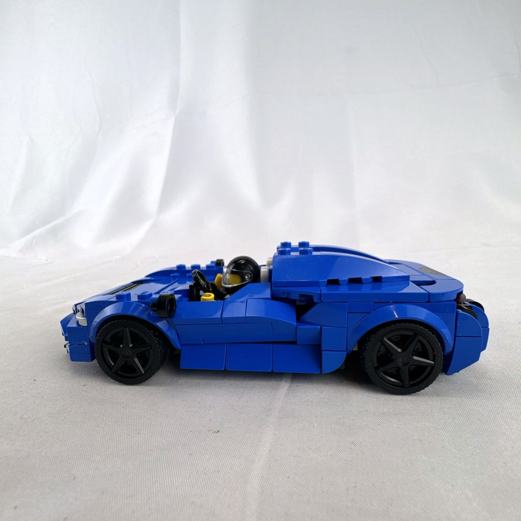Assembled LEGO Speed Champions McLaren Elva set 76902 in blue with racing minifigure and original box