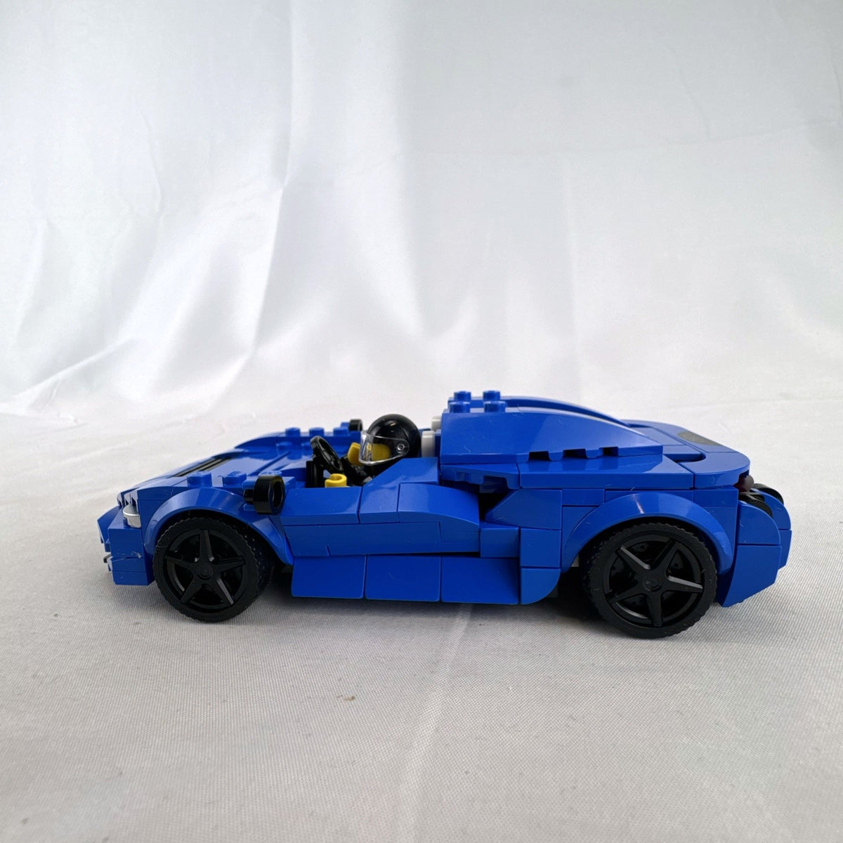 Assembled LEGO Speed Champions McLaren Elva set 76902 in blue with racing minifigure and original box
