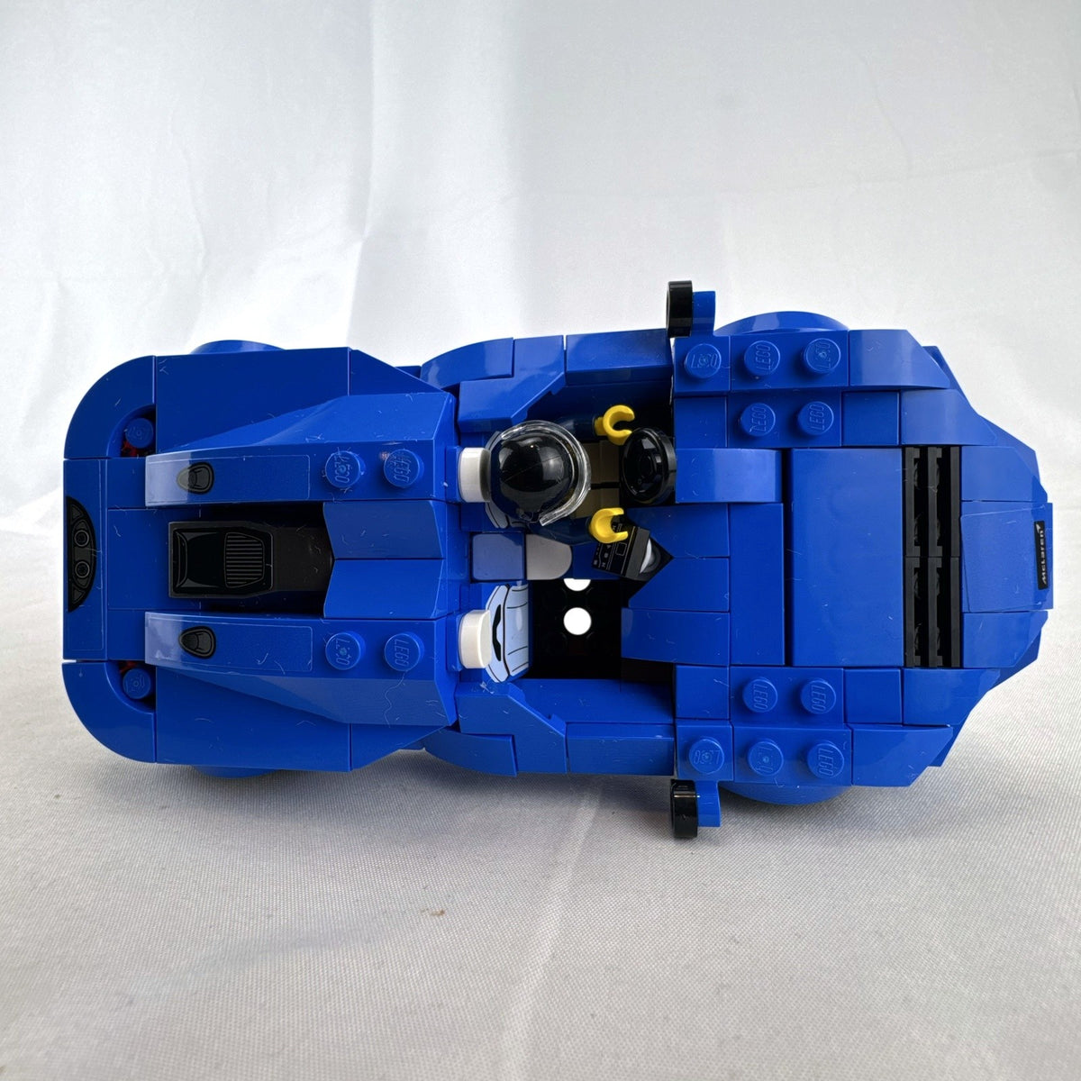 Assembled LEGO Speed Champions McLaren Elva set 76902 in blue with racing minifigure and original box