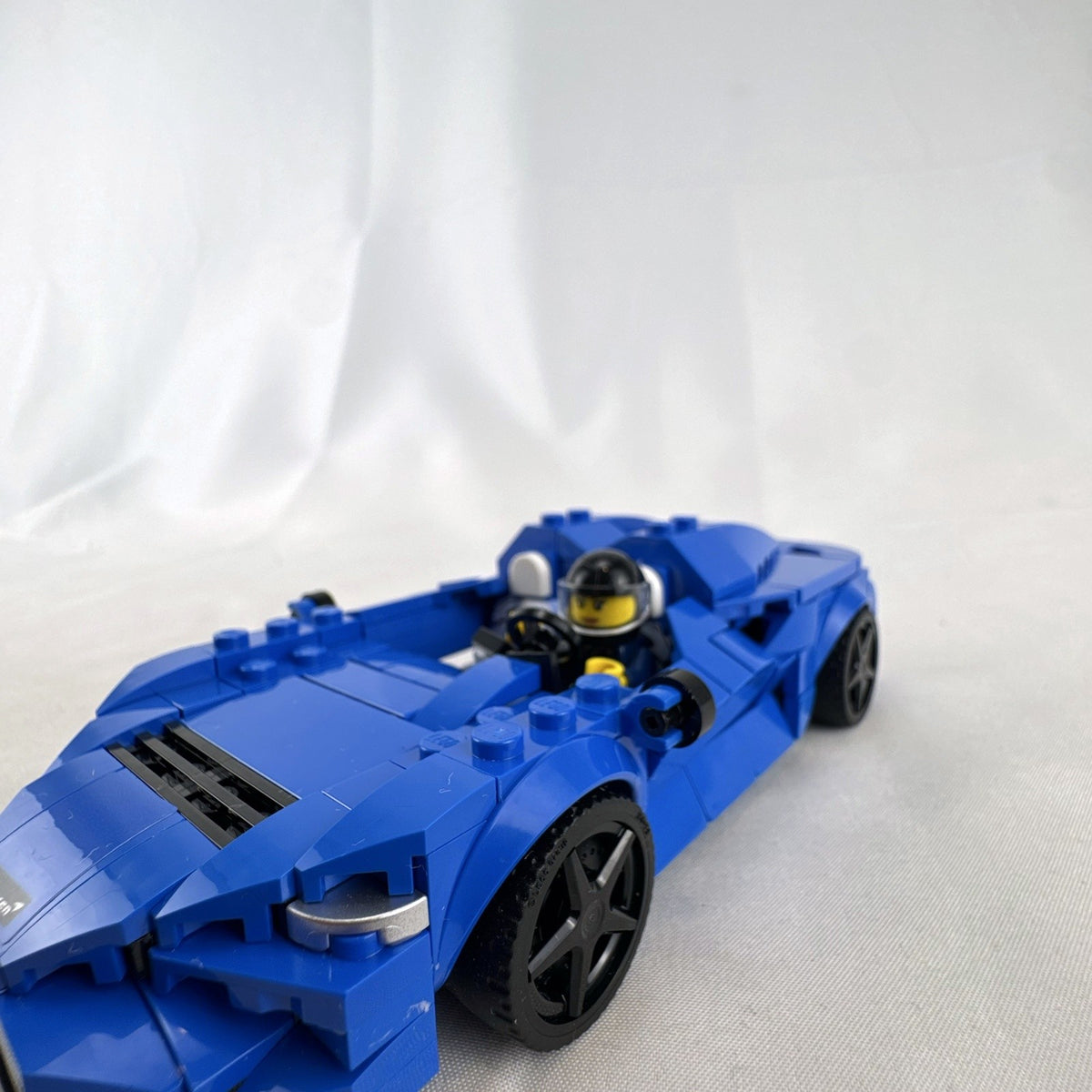 Assembled LEGO Speed Champions McLaren Elva set 76902 in blue with racing minifigure and original box