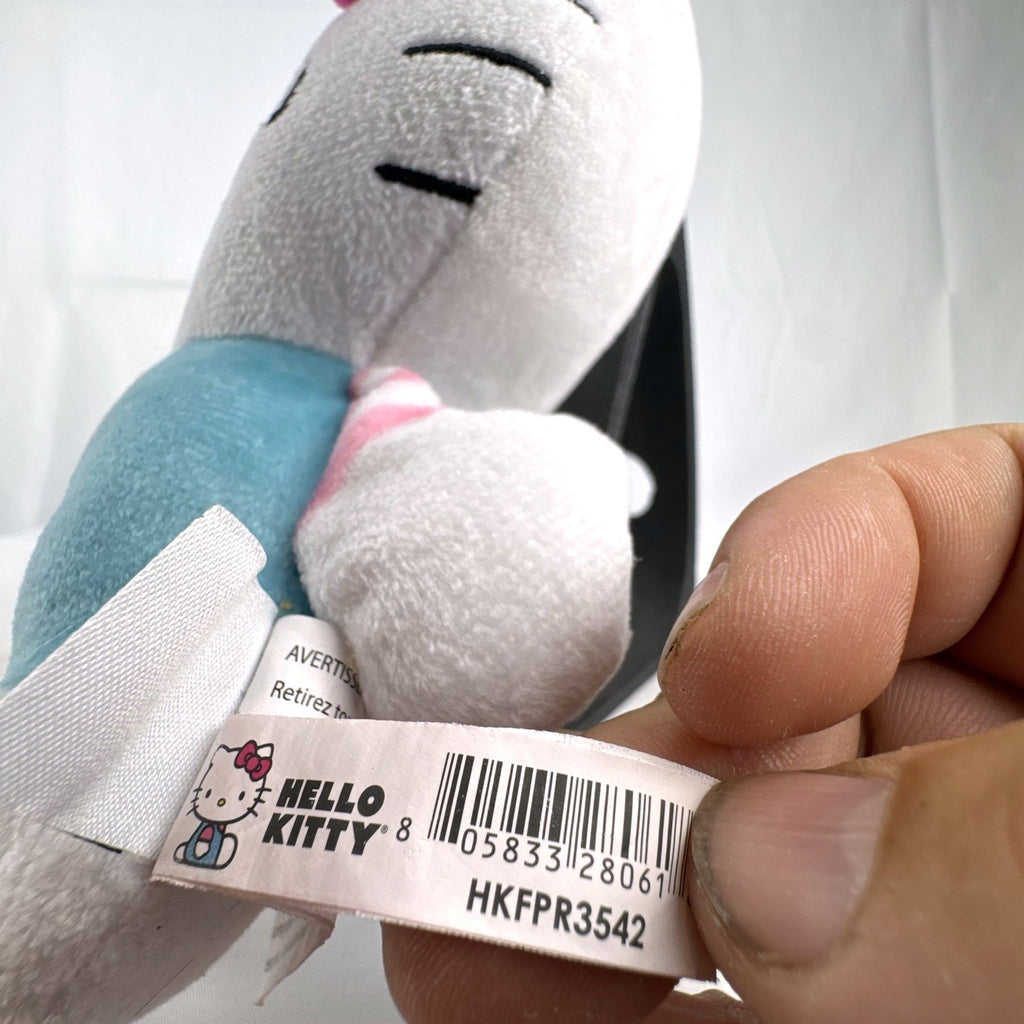 Pair of Sanrio Hello Kitty plush dolls wearing blue and pink overalls, measuring approximately 7 inches tall.