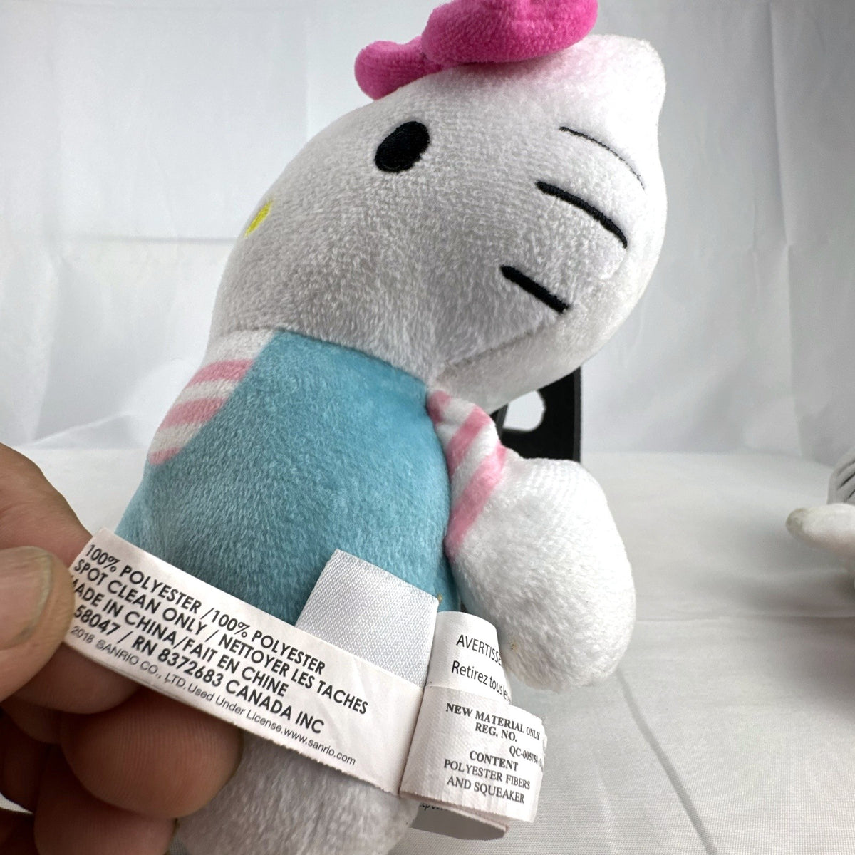 Pair of Sanrio Hello Kitty plush dolls wearing blue and pink overalls, measuring approximately 7 inches tall.