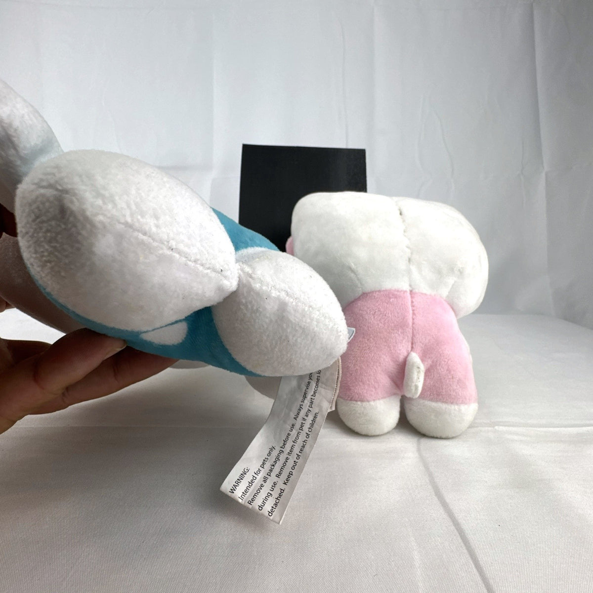 Pair of Sanrio Hello Kitty plush dolls wearing blue and pink overalls, measuring approximately 7 inches tall.