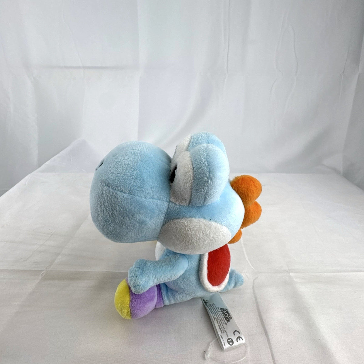 San-ei Nintendo light blue Yoshi plush stuffed animal showing red saddle shell and purple shoes