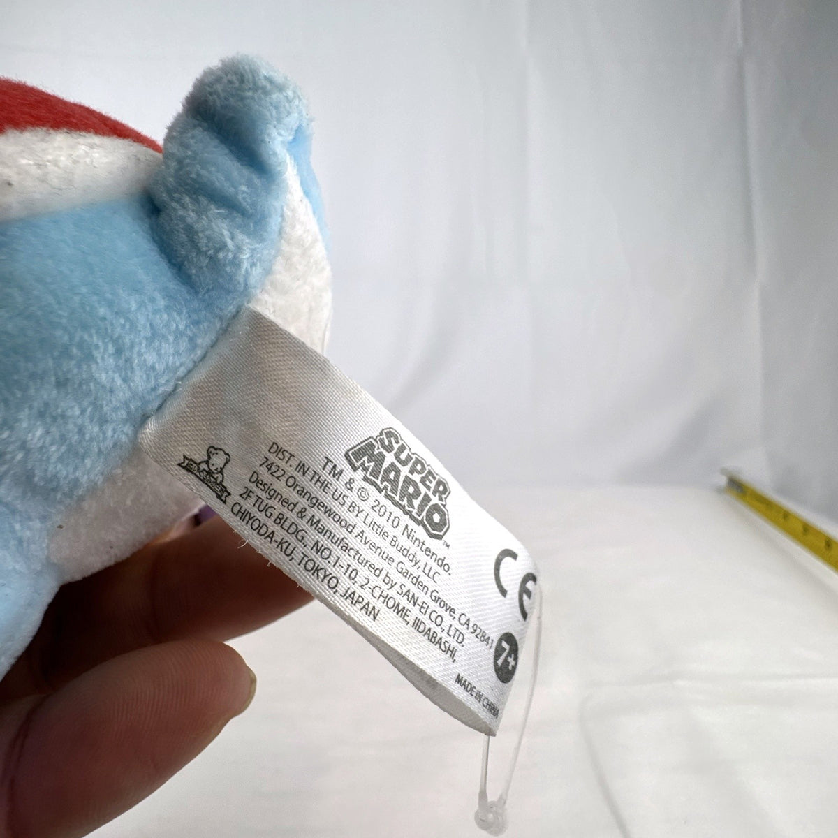 San-ei Nintendo light blue Yoshi plush stuffed animal showing red saddle shell and purple shoes