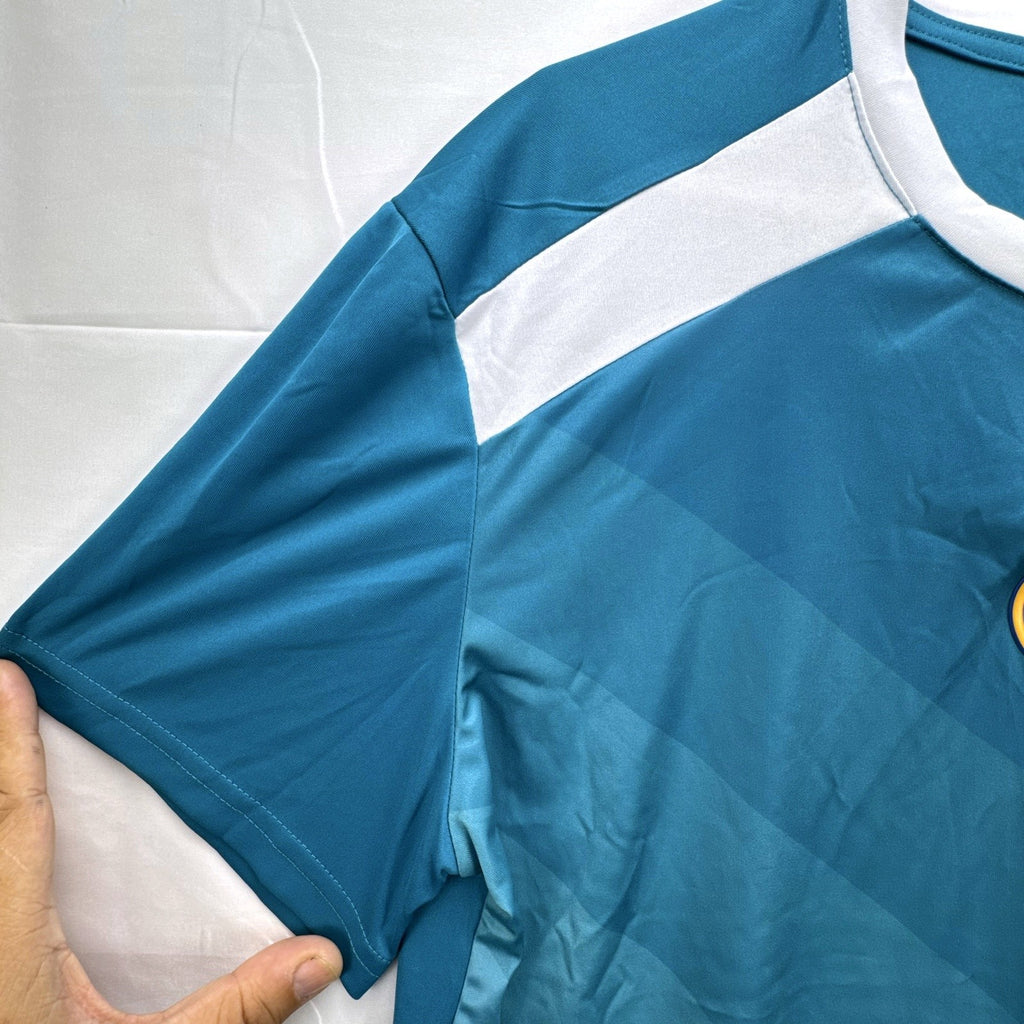 Real Madrid official men's size large soccer jersey in teal blue chevron pattern