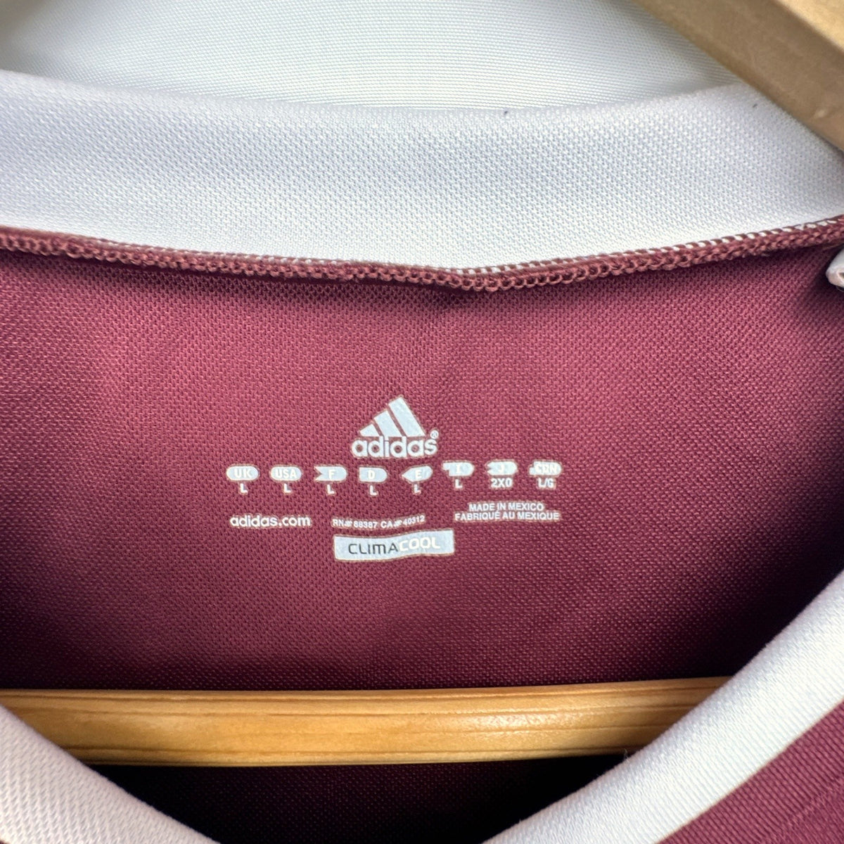 Men's size Large burgundy adidas MLS training soccer jersey with white stripes and league patch