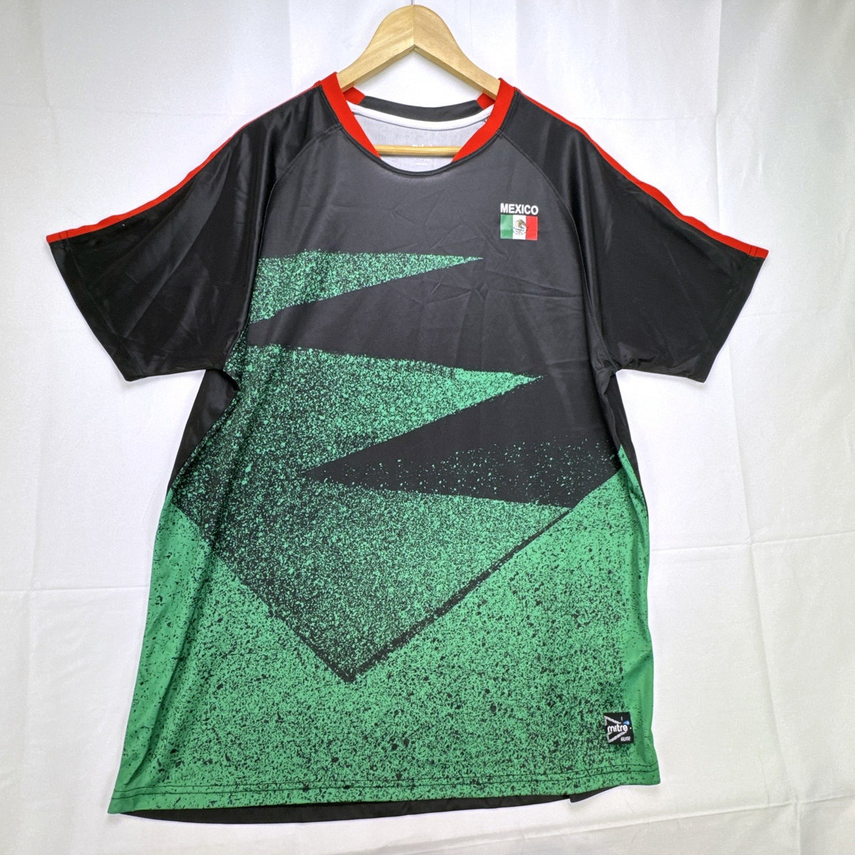 Mitre Mexico soccer jersey in black with green geometric print and red trim, men's size XL.